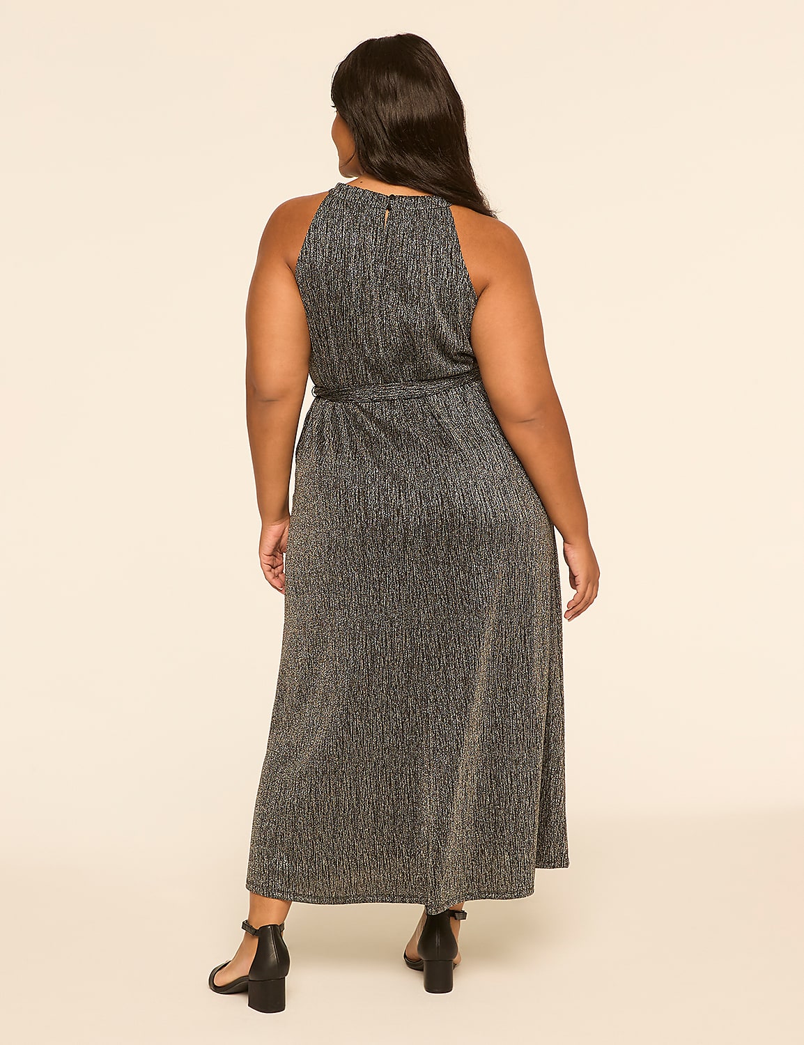 A woman in a sparkly silver dress stands against a plain, light-colored background. Product Image 2