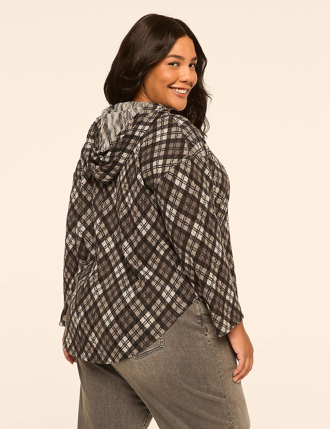 A woman in a plaid hoodie and jeans smiles over her shoulder against a plain, light-colored background. Product Image 2