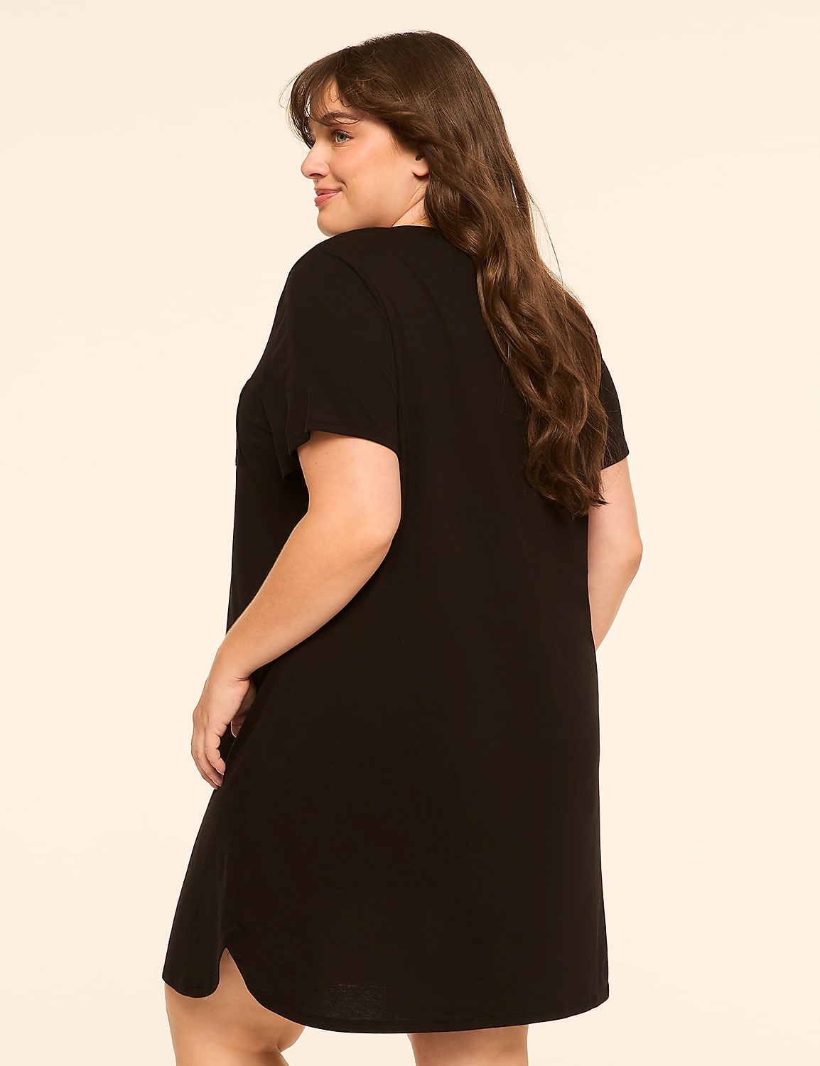 A woman in a black t-shirt dress stands against a plain, light-colored background. Product Image 2