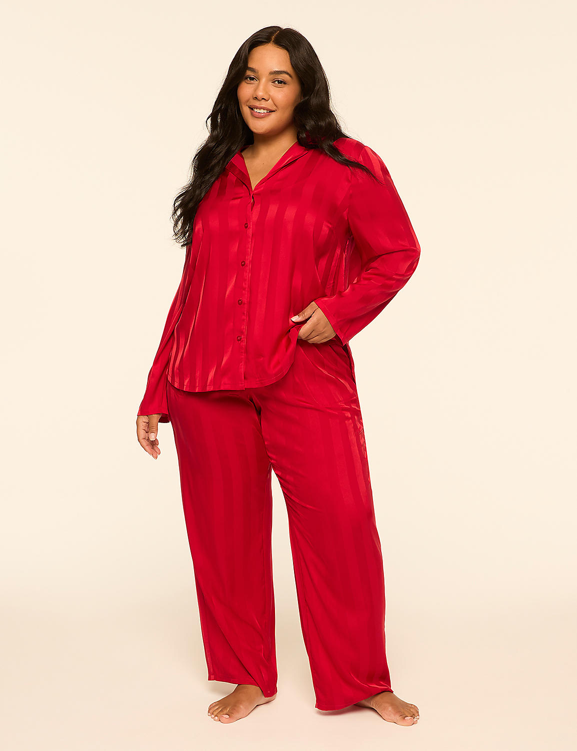 A woman in a red satin pajama set stands against a plain, light-colored background. Product Image 1