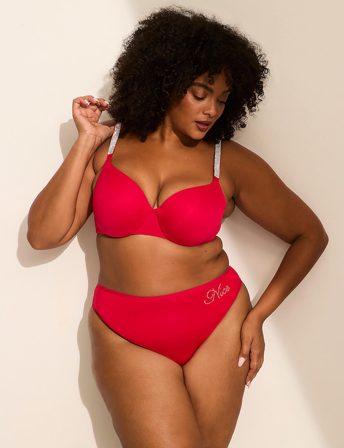 A woman in a red bra and underwear stands against a plain, light-colored wall. Product Image 4