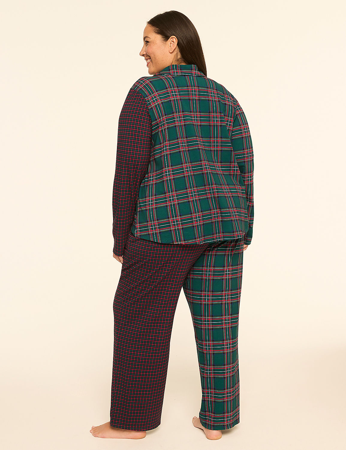 A woman stands in pajamas with a plaid top and patterned pants against a plain, light background. Product Image 2