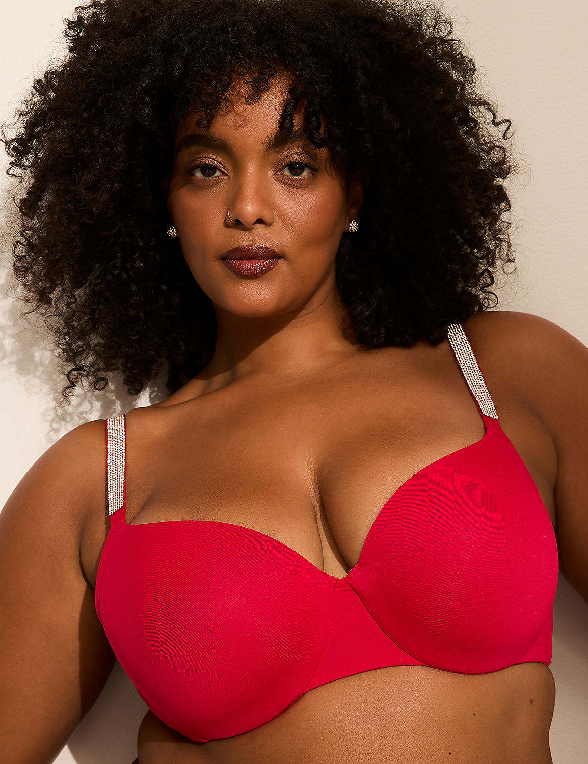 A woman with dark curly hair and a red bra with sparkly straps stands against a plain white background. Product Image 2