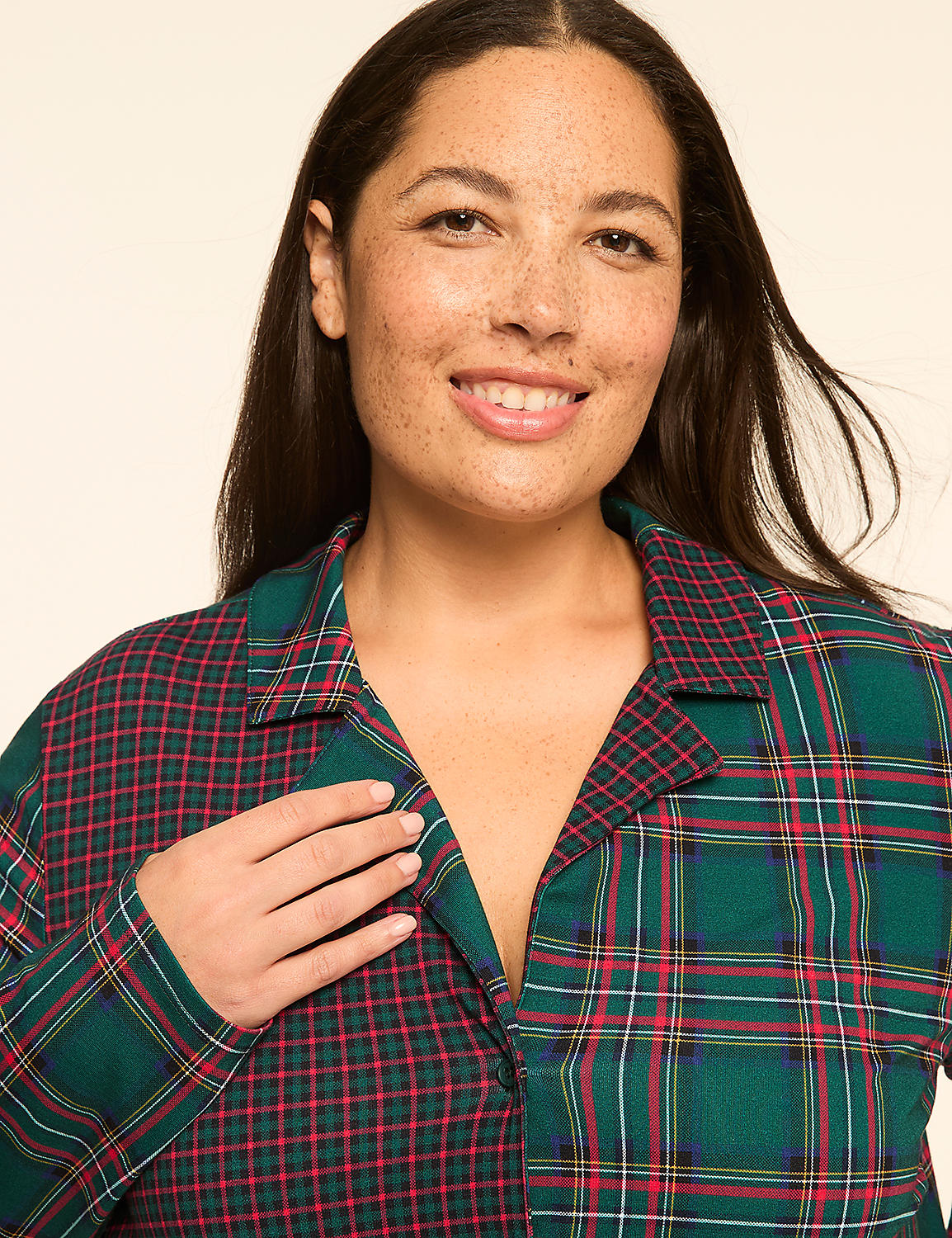 A woman with dark hair and freckles smiles at the camera, wearing a plaid pajama top against a plain background. Product Image 4