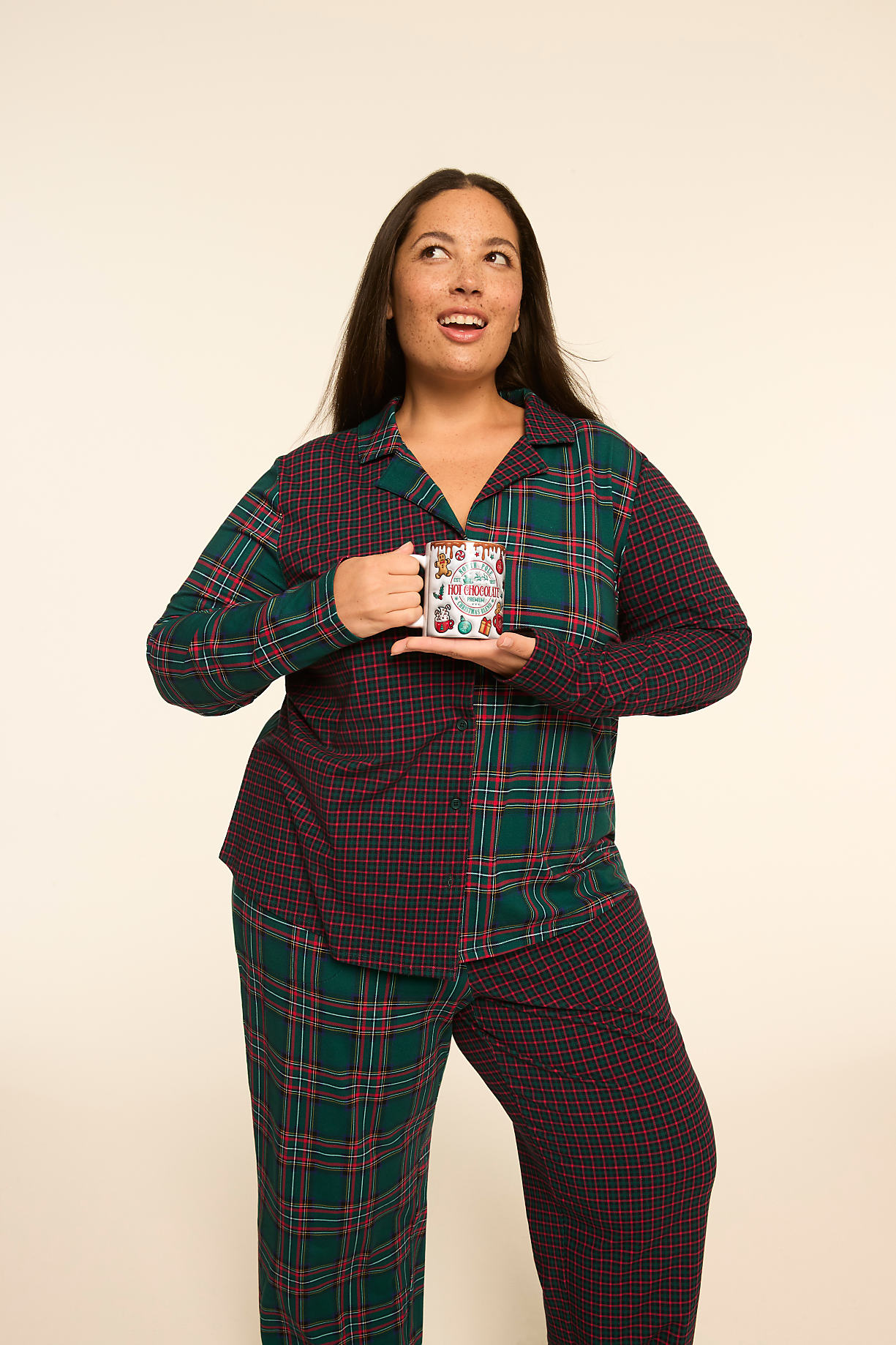 A woman in plaid pajamas holds a mug in front of a plain, light-colored background. Product Image 6