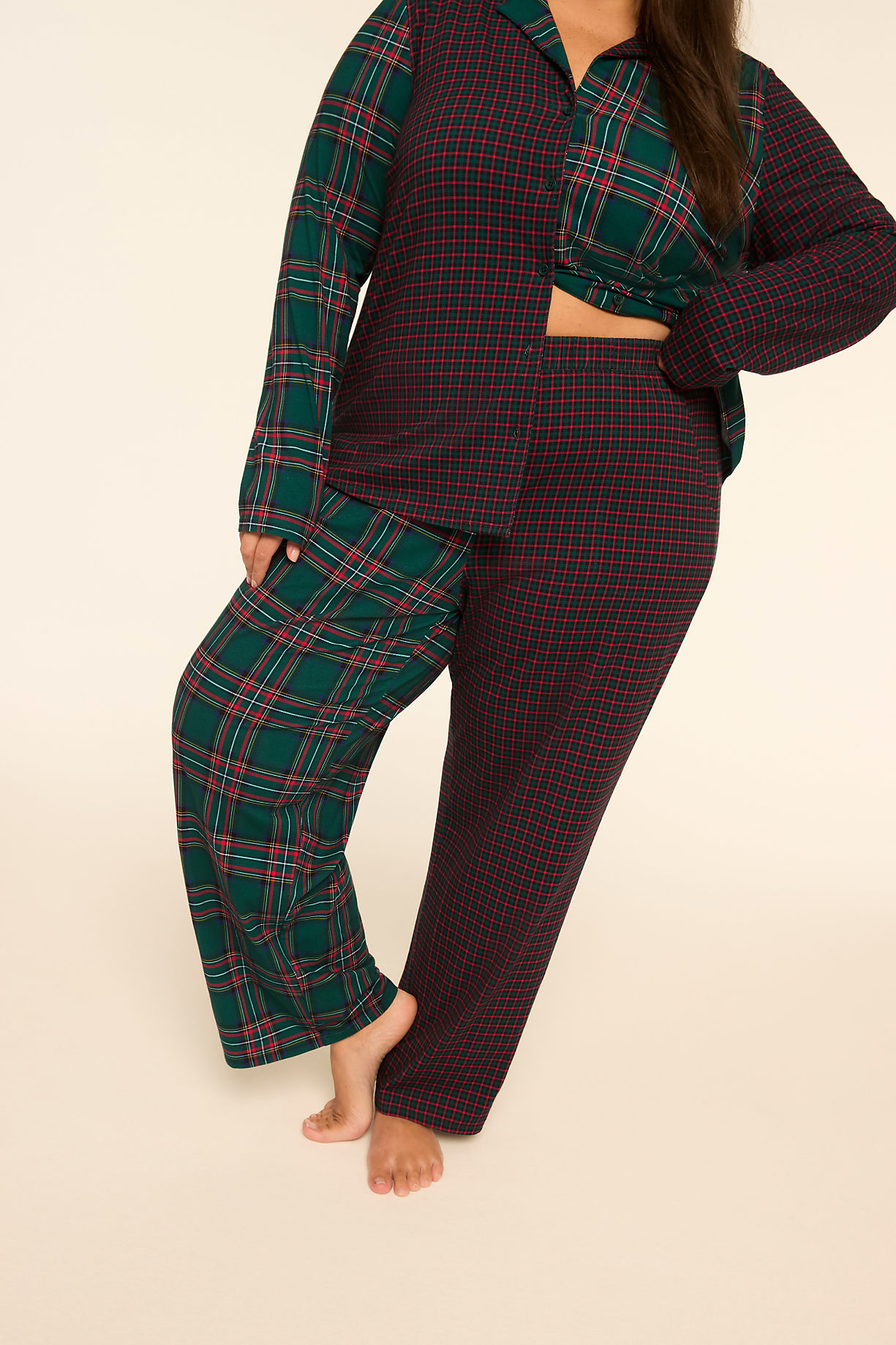 A person stands in the foreground wearing mismatched plaid pajamas against a plain, light-colored background. Product Image 8