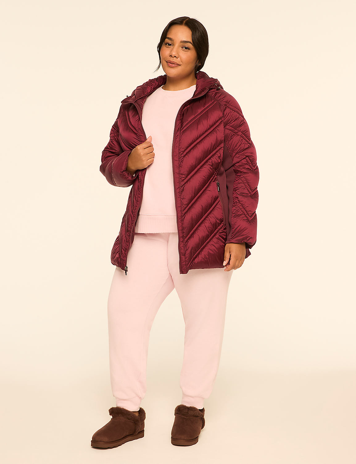 A woman in a burgundy puffer jacket and pink loungewear stands against a plain, light-colored background. Product Image 3