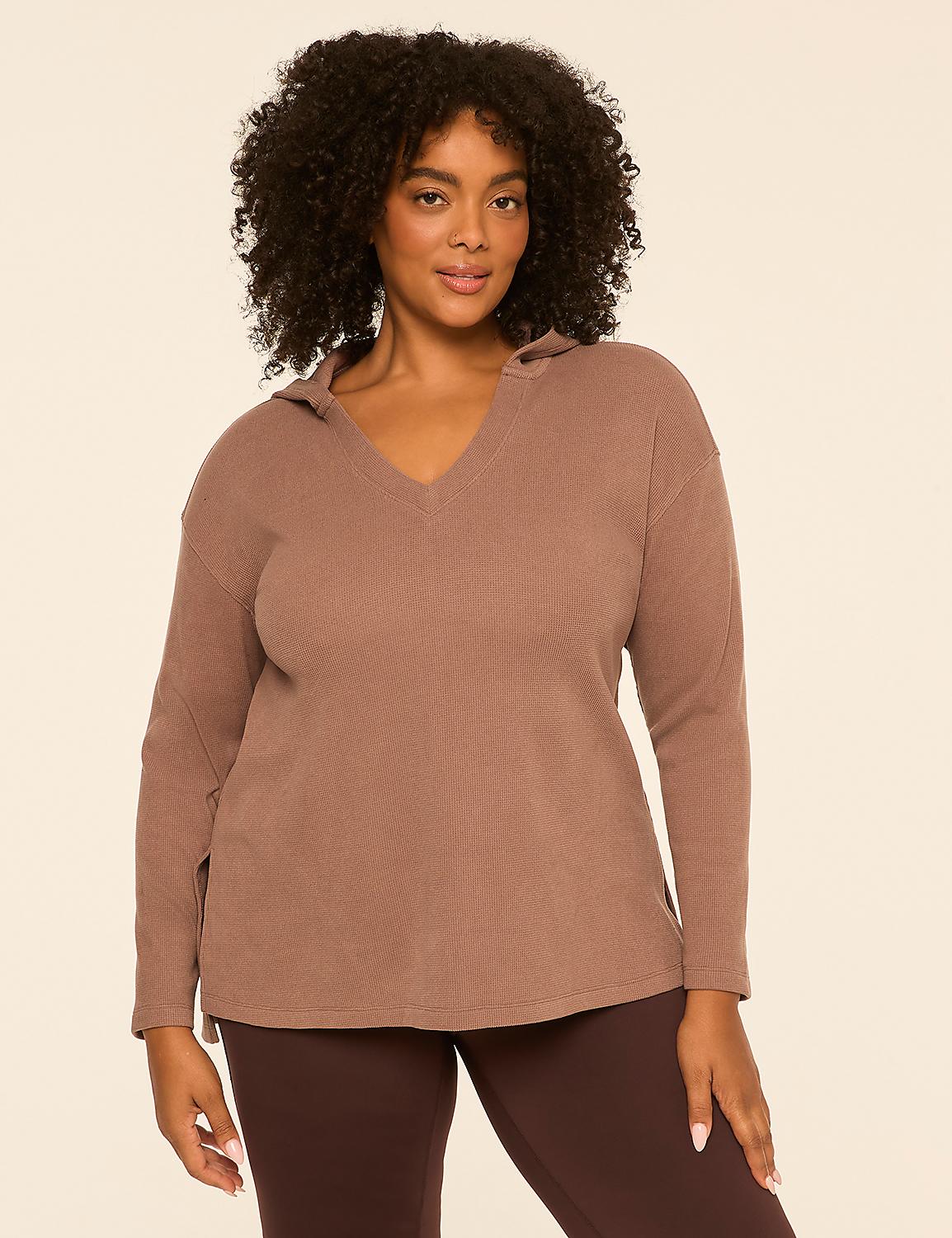 A woman in a brown hoodie and leggings stands against a plain, light-colored background. Product Image 1