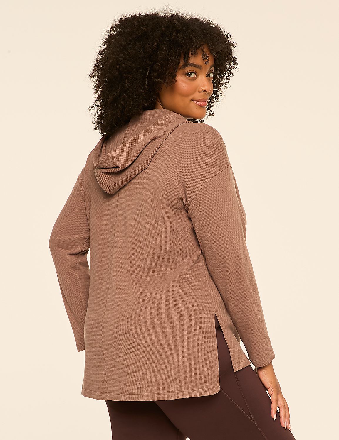 A woman in a brown waffle-knit hoodie and dark leggings poses against a plain beige background. Product Image 2