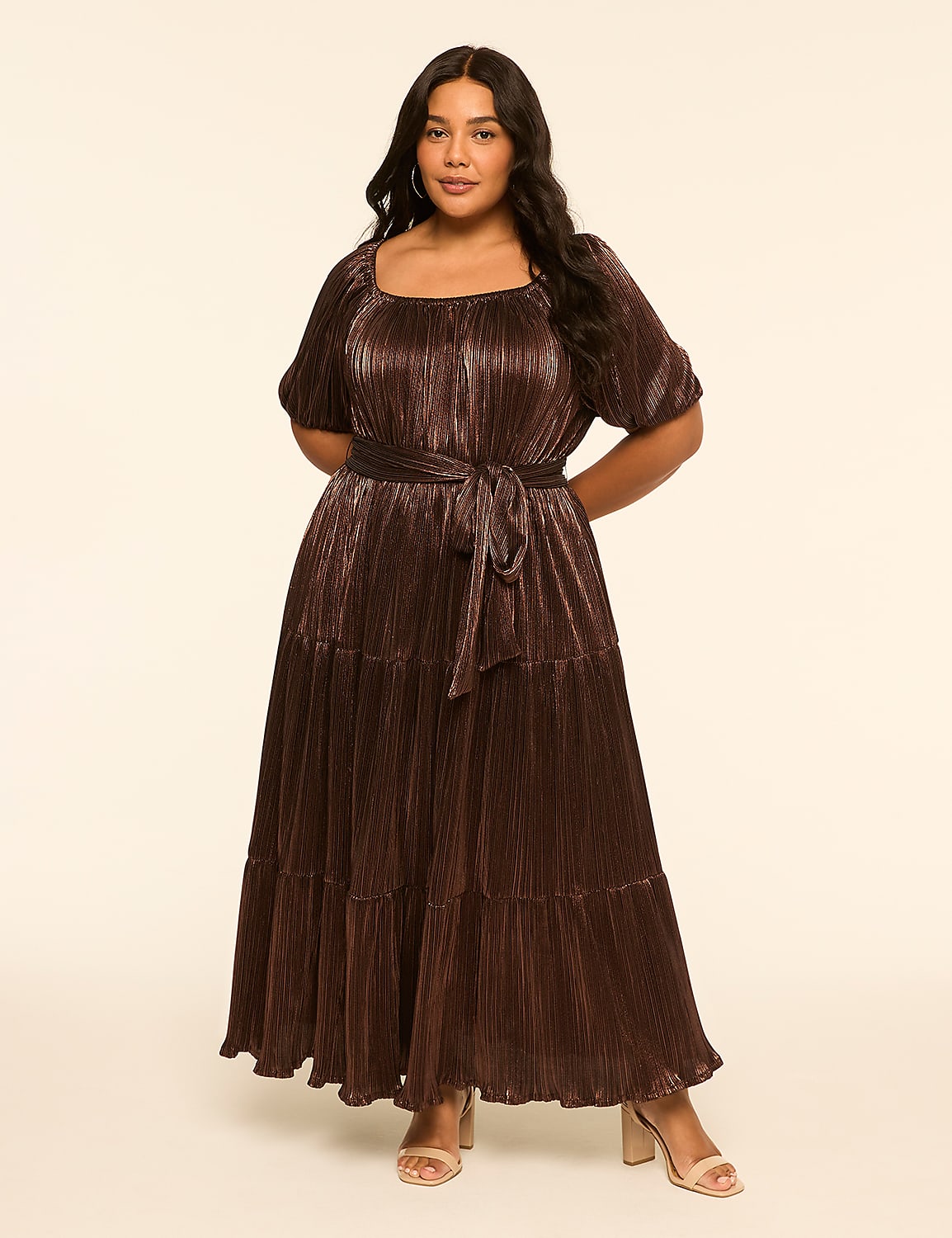 A woman in a shimmering brown tiered dress stands against a plain, light-colored background. Product Image 1