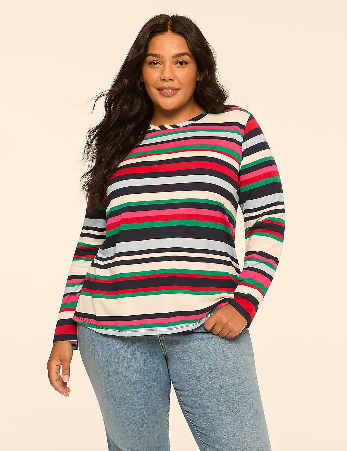 A woman with dark hair and a striped long-sleeved shirt stands against a plain, light-colored background. Product Image 1