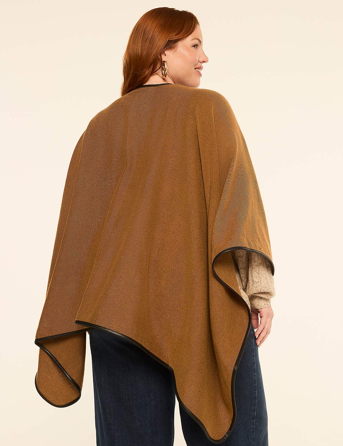 A woman in a brown poncho with leather trim stands against a plain, light-colored background. Product Image 2