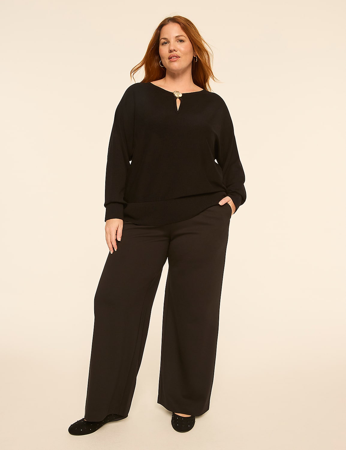 A woman in a black top and wide-leg pants stands against a plain, light-colored background. Product Image 3