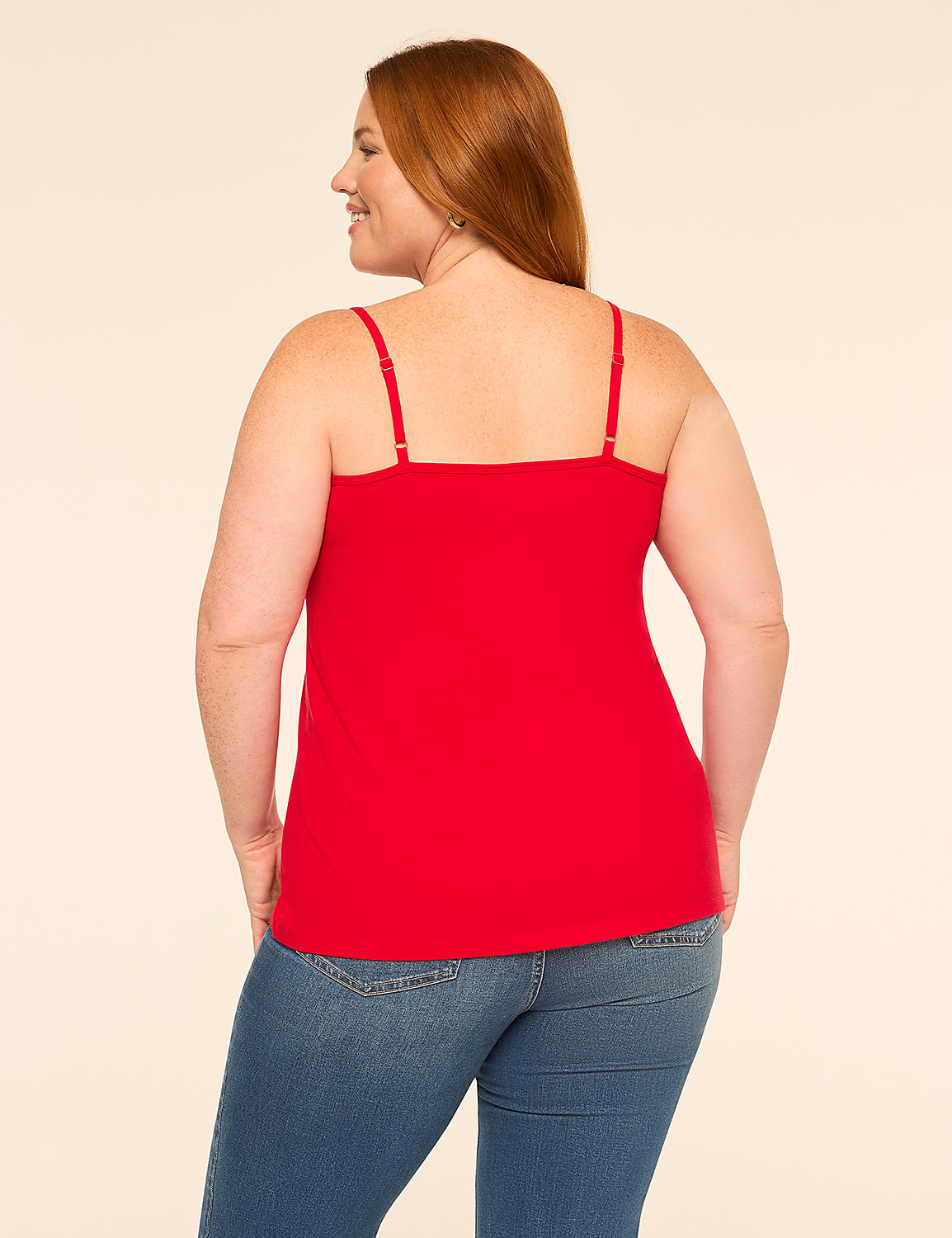 A woman in a red camisole and blue jeans stands against a plain, light-colored background. Product Image 2
