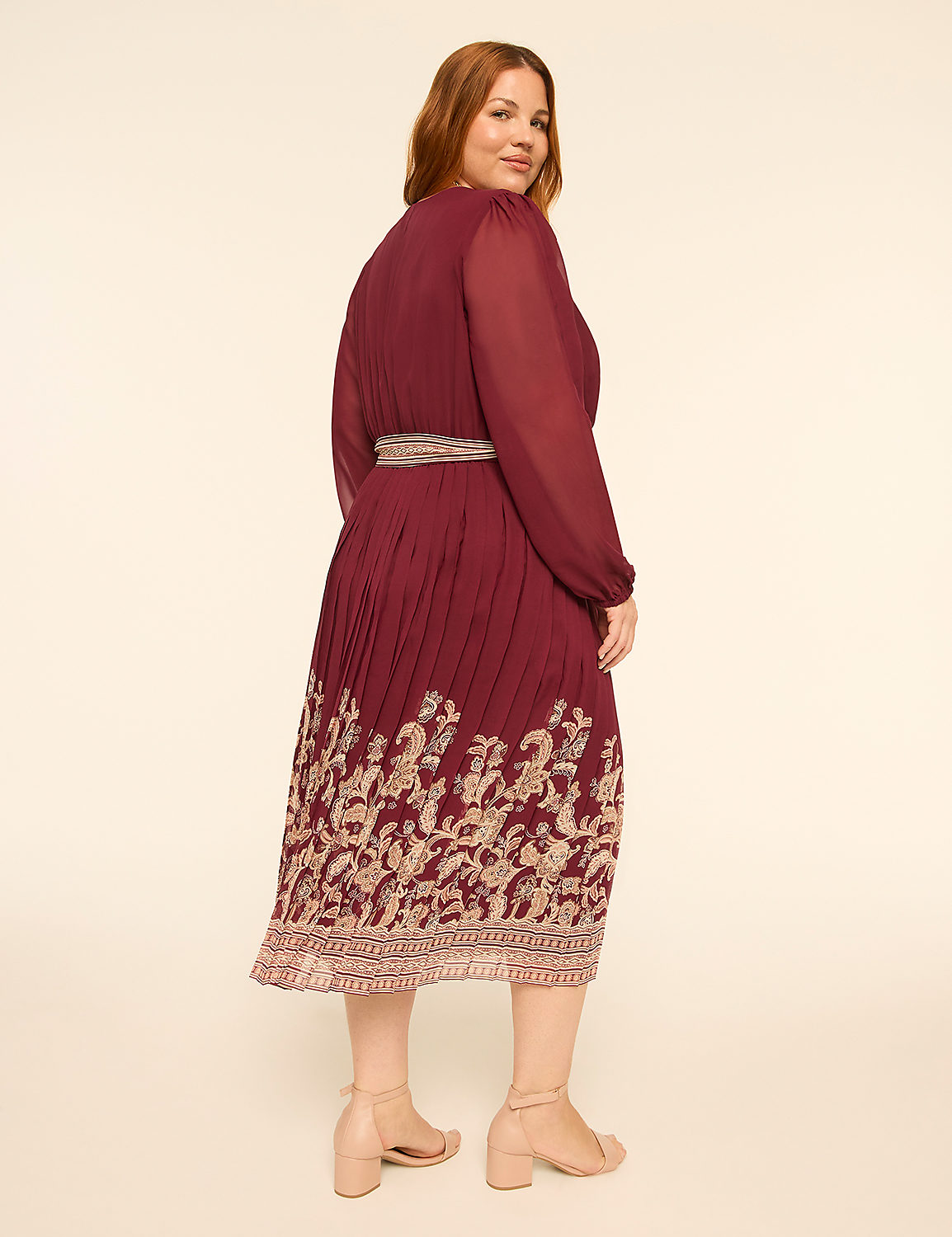 A woman in a burgundy dress with a floral hem stands against a plain, light-colored background. Product Image 2