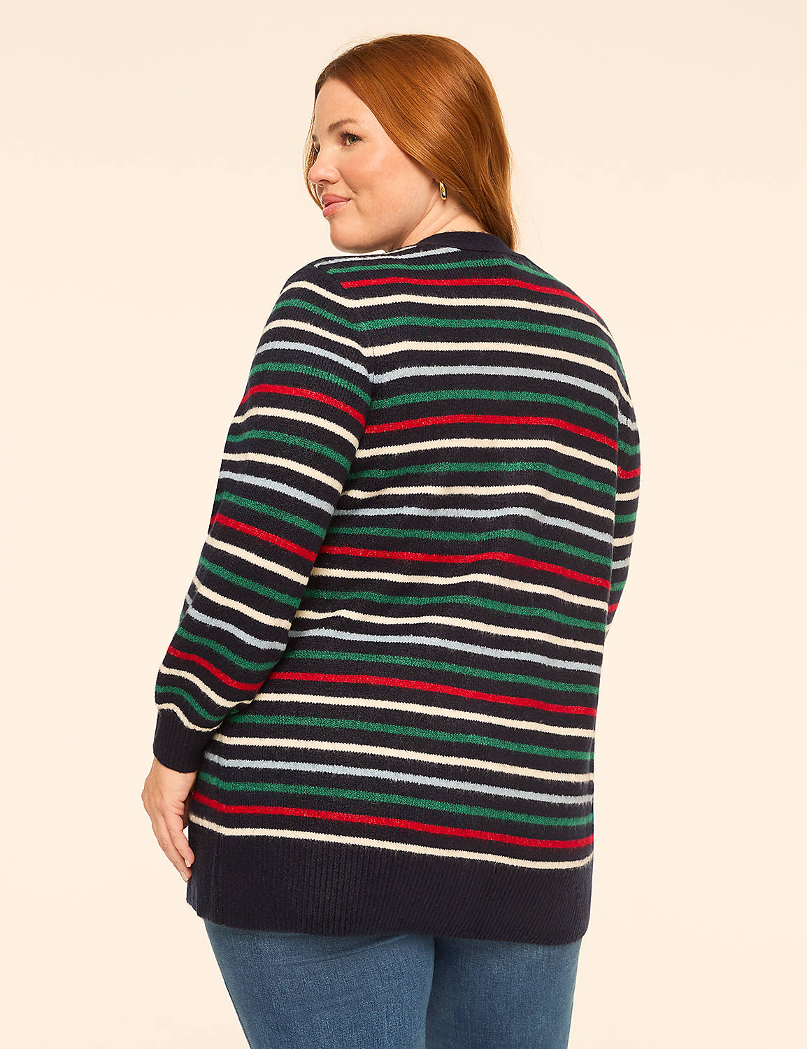 A woman with red hair wearing a striped sweater stands against a plain, light-colored background. Product Image 2