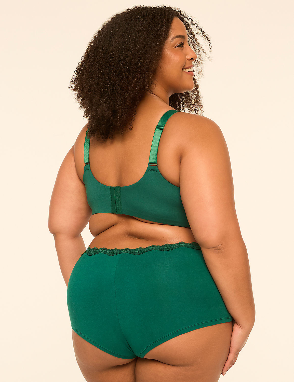 A woman in a green bra and matching underwear stands against a plain, light-colored background. Product Image 2
