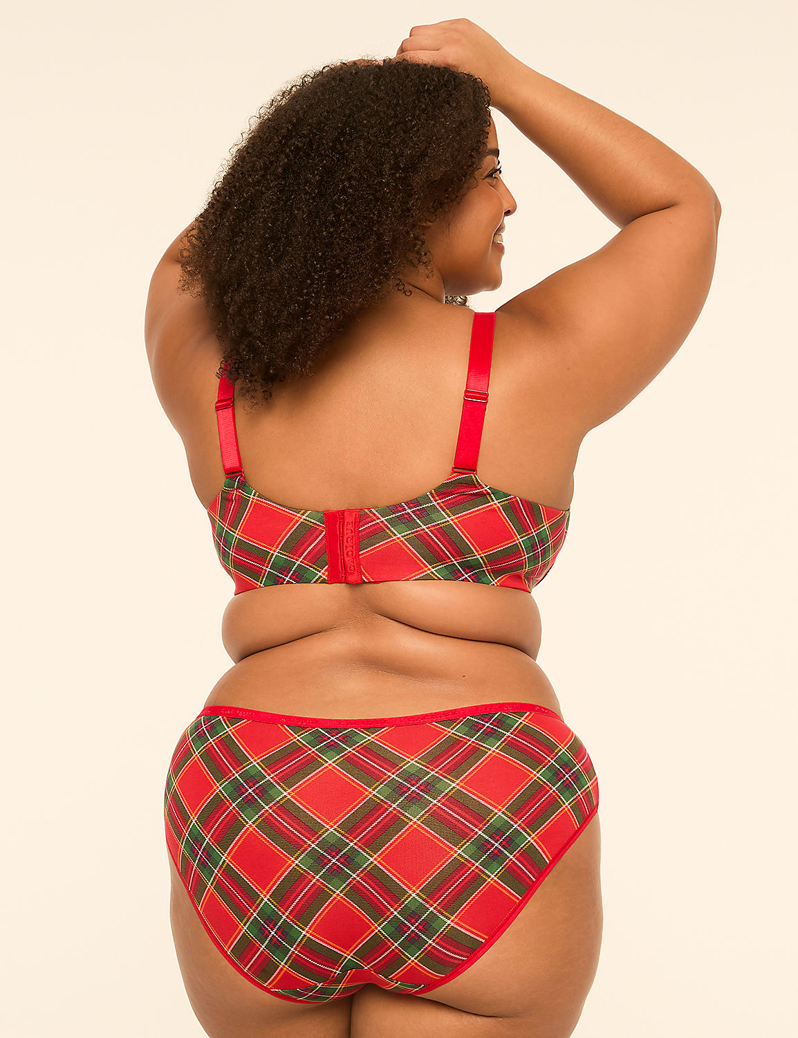 A woman in a red and green plaid bra and underwear stands with her arms raised against a plain, light-colored background. Product Image 2