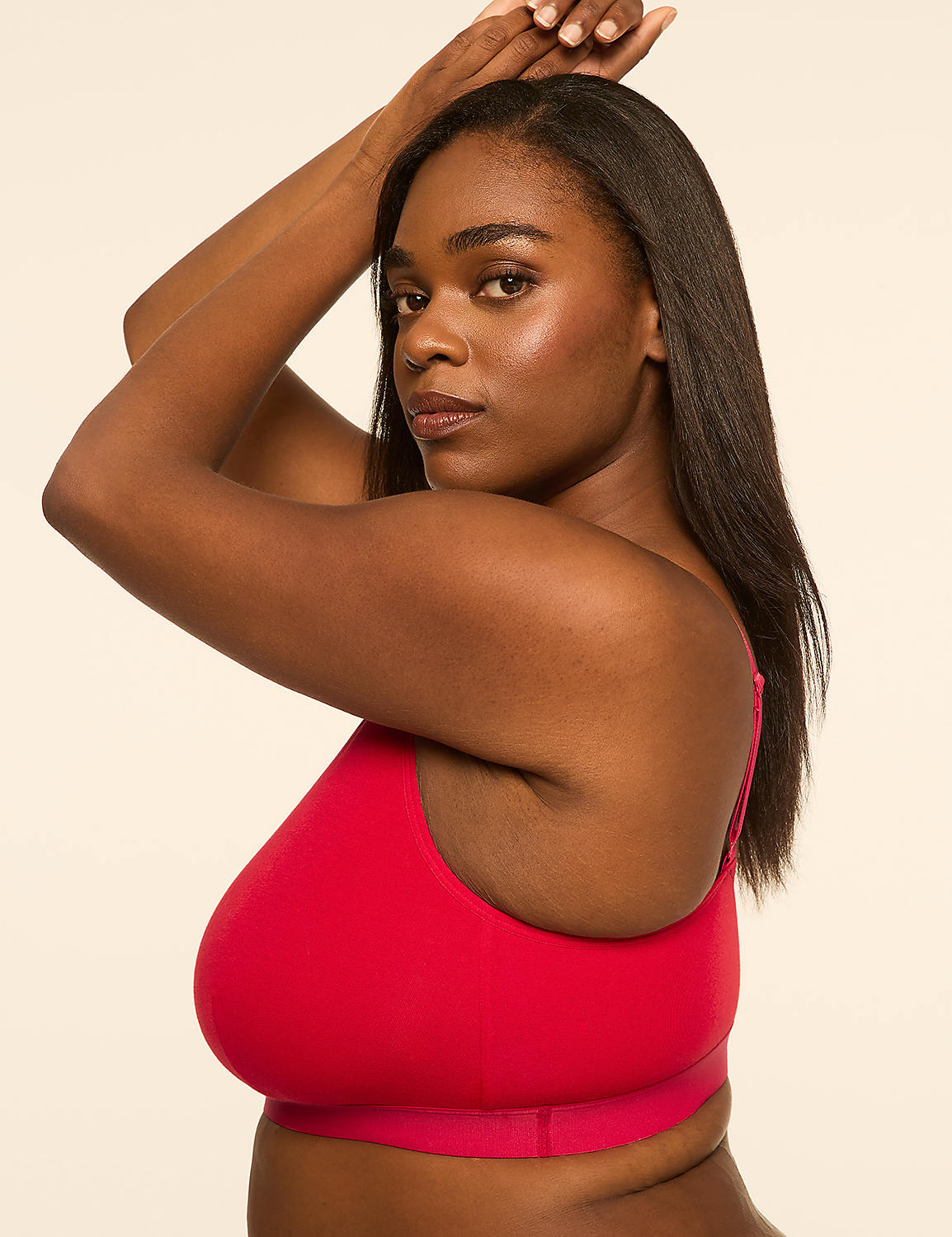 A woman in a red bra poses with her arms raised against a plain, light-colored background. Product Image 3