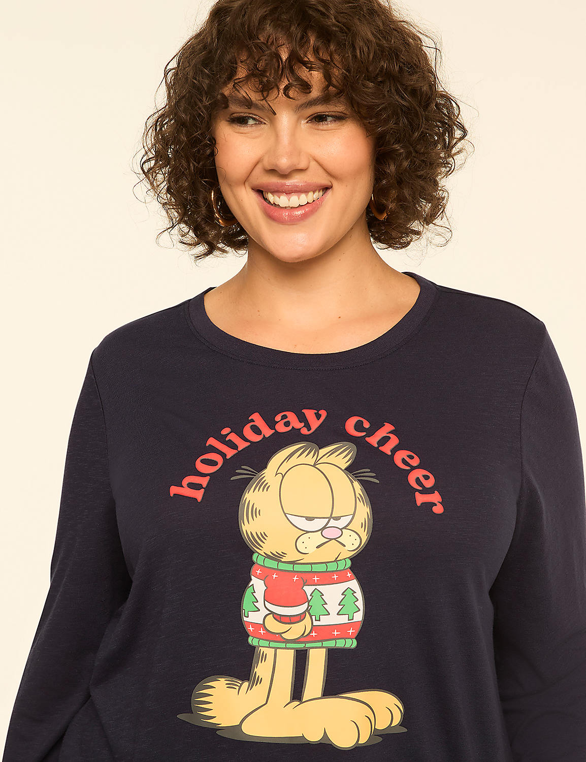 A smiling woman in a navy blue shirt with a grumpy Garfield in a Christmas sweater is shown against a plain, light background. Product Image 4