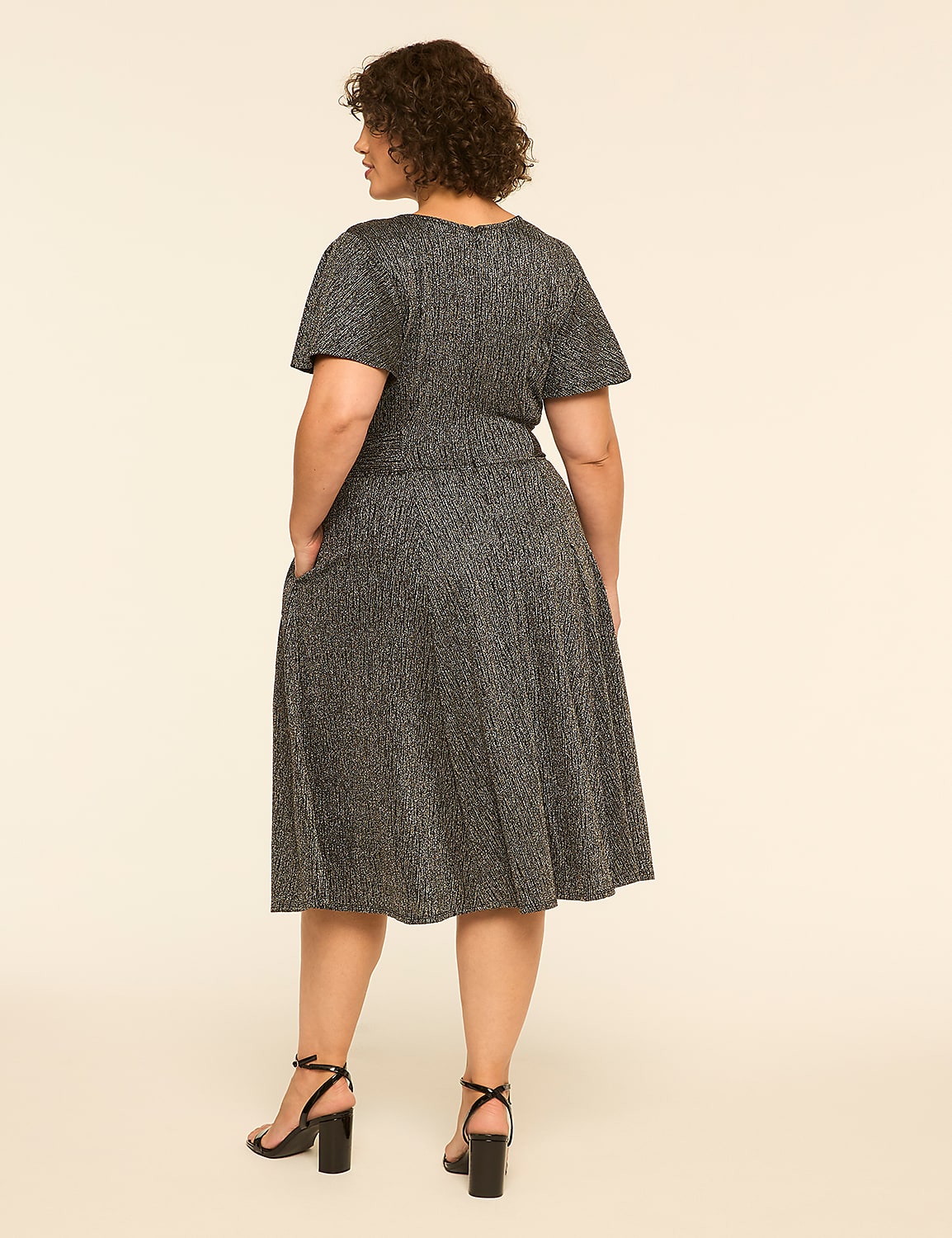 A woman in a sparkly black dress stands with her back to the viewer against a plain, light-colored background. Product Image 2