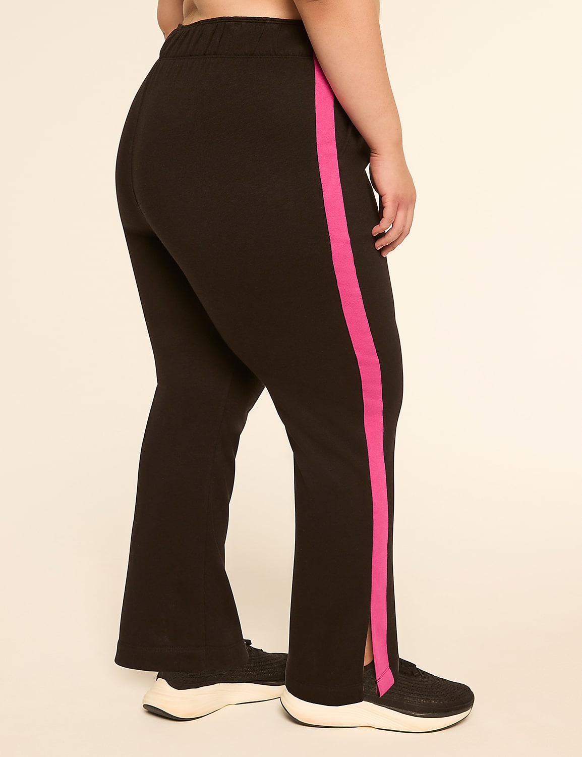 A person wearing black pants with a pink stripe stands against a plain, light-colored background. Product Image 2