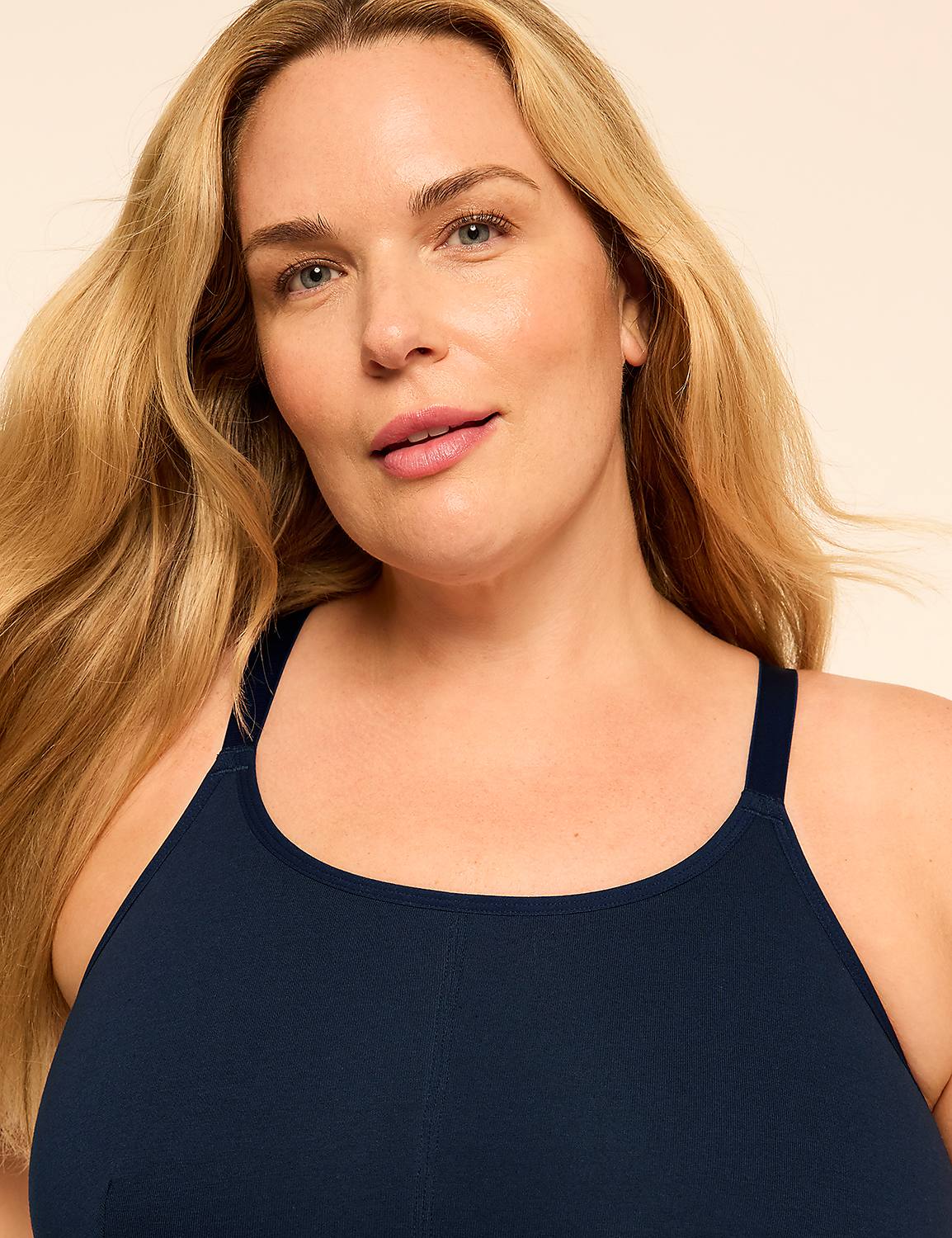 A blonde woman wearing a navy blue tank top poses against a plain, light-colored background. Product Image 4