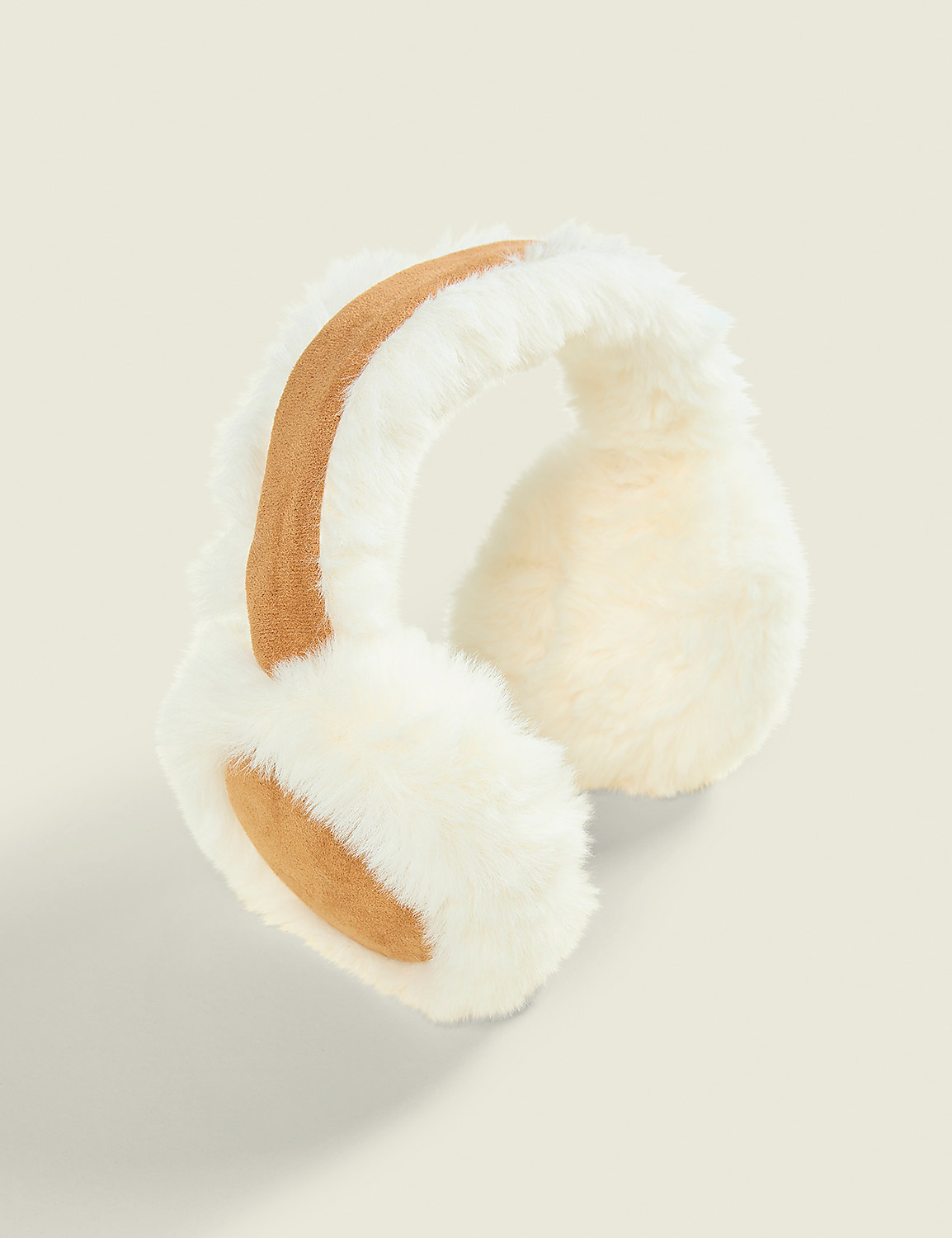 White and tan faux-fur earmuffs sit against a plain, light beige background. Product Image 1
