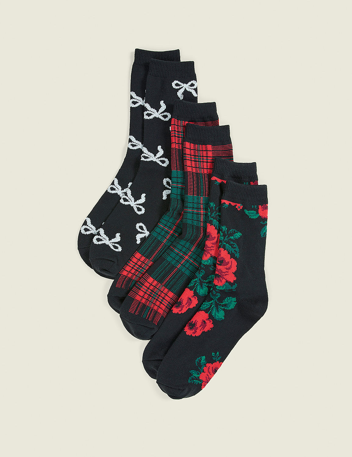 Six pairs of patterned black socks are arranged in a fan shape against a plain, light beige background. Product Image 1