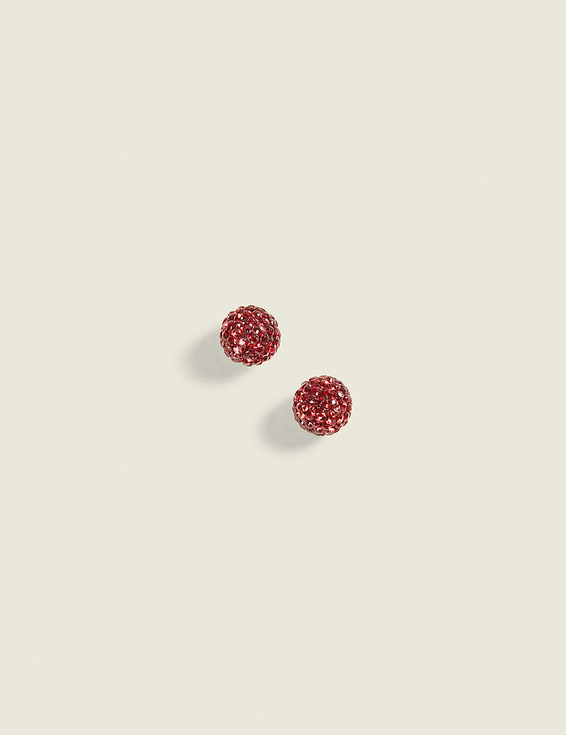 Two sparkling red glittery spheres sit on a plain, light beige background. Product Image 1