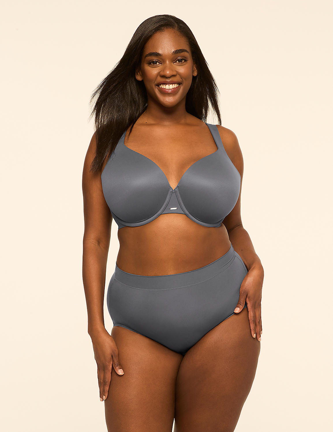 A smiling woman wearing a grey two-piece swimsuit stands against a plain, light-colored background. Product Image 4