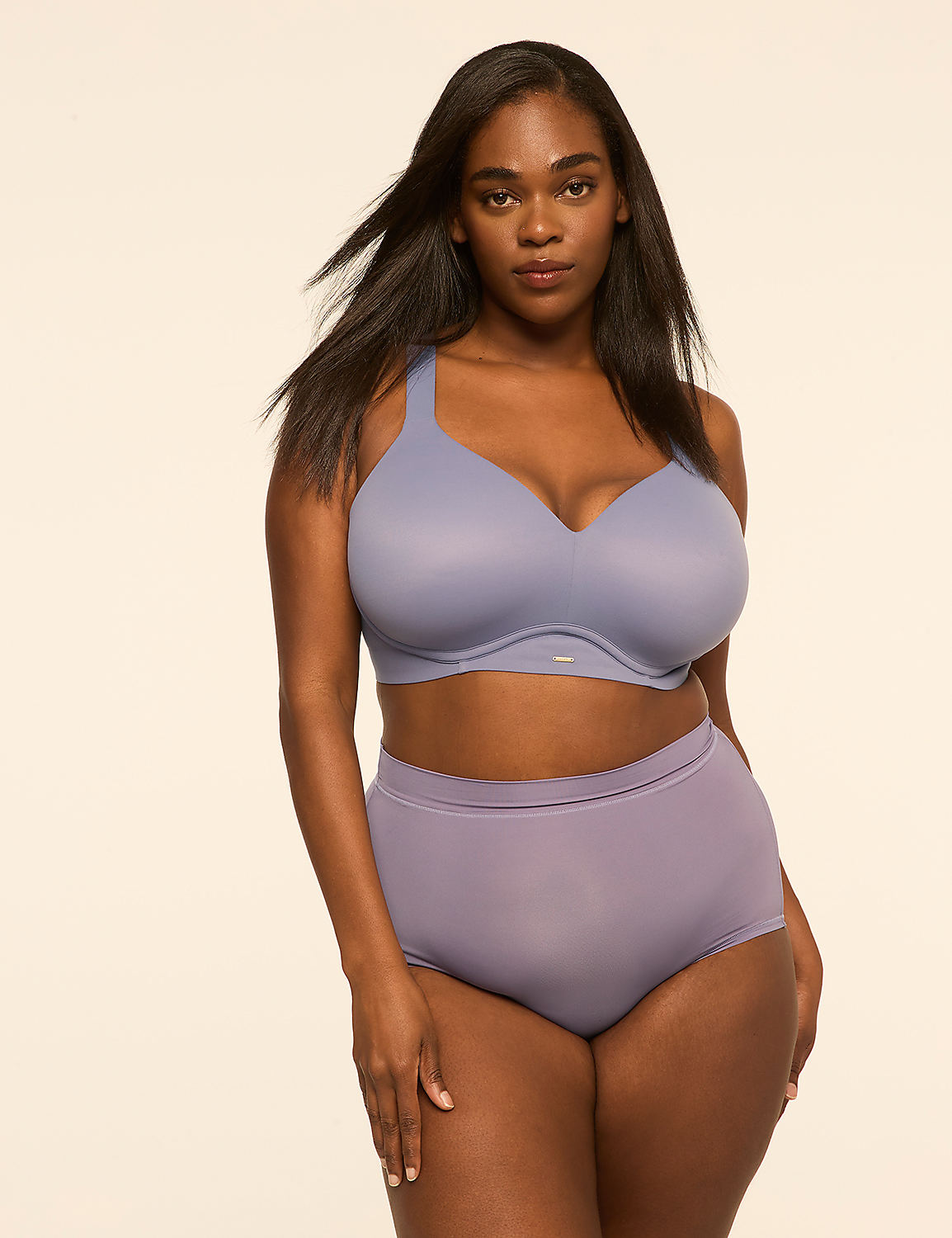 A woman wearing a purple lingerie set stands against a plain, light-colored background. Product Image 4