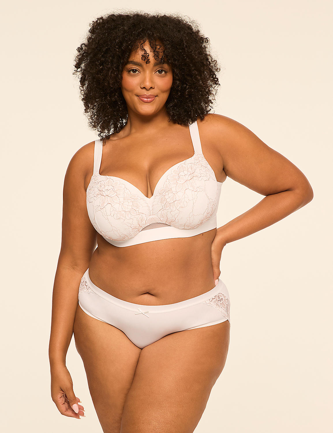 A woman with curly hair wearing a white lace lingerie set poses against a plain, light-colored background. Product Image 4