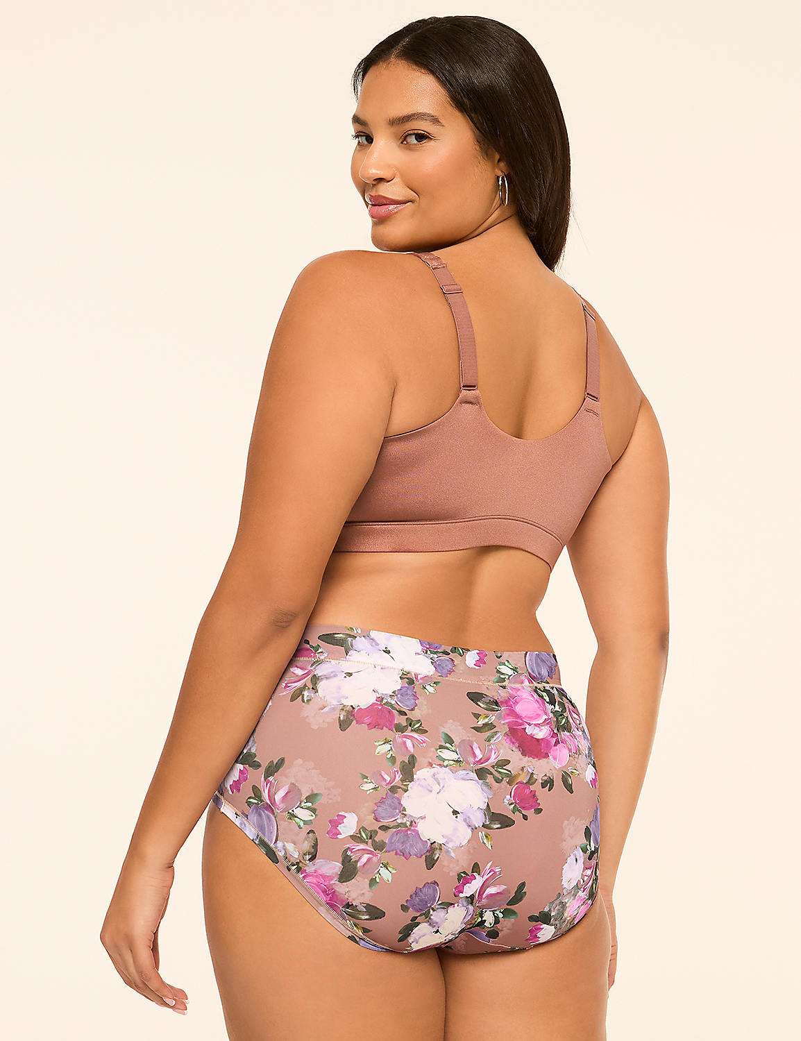 A woman wearing a brown bikini top and floral print bottoms poses against a plain, light-colored background. Product Image 2