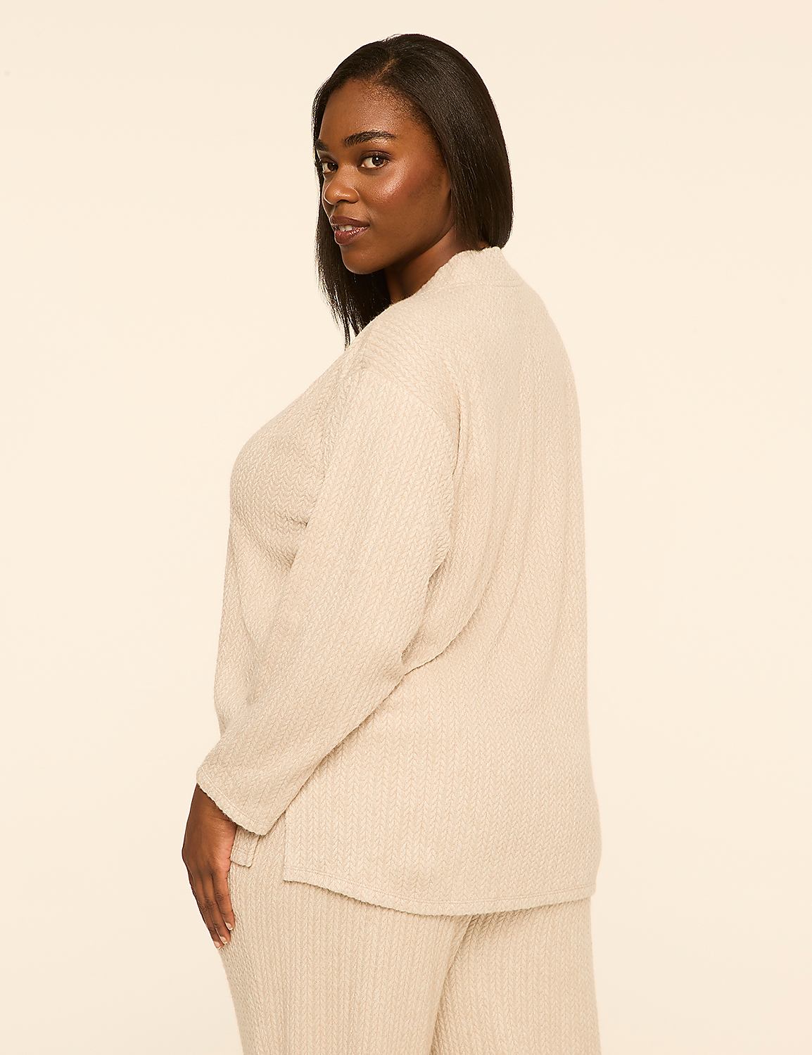 A woman wearing a beige ribbed lounge set stands against a plain, light-colored background. Product Image 2