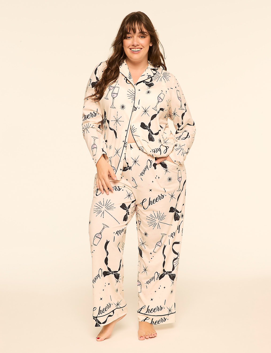A smiling woman wears champagne-themed pajamas against a plain, light-colored background. Product Image 1