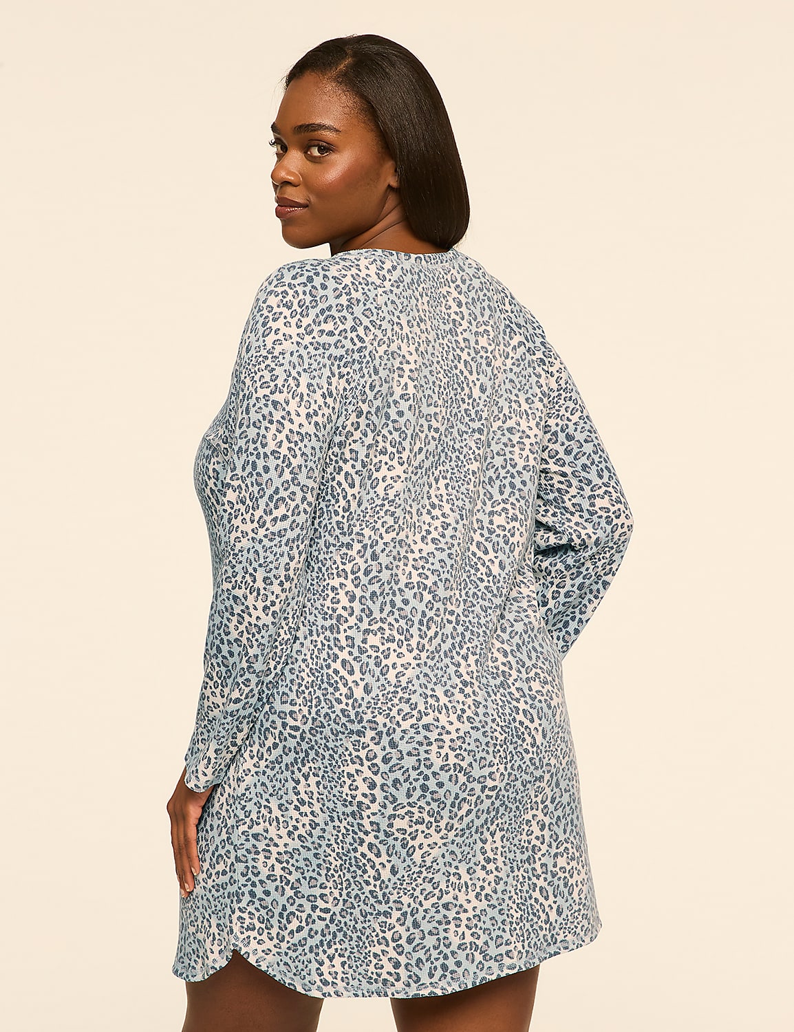 A woman wearing a blue and white leopard print tunic stands against a plain, light-colored background. Product Image 2