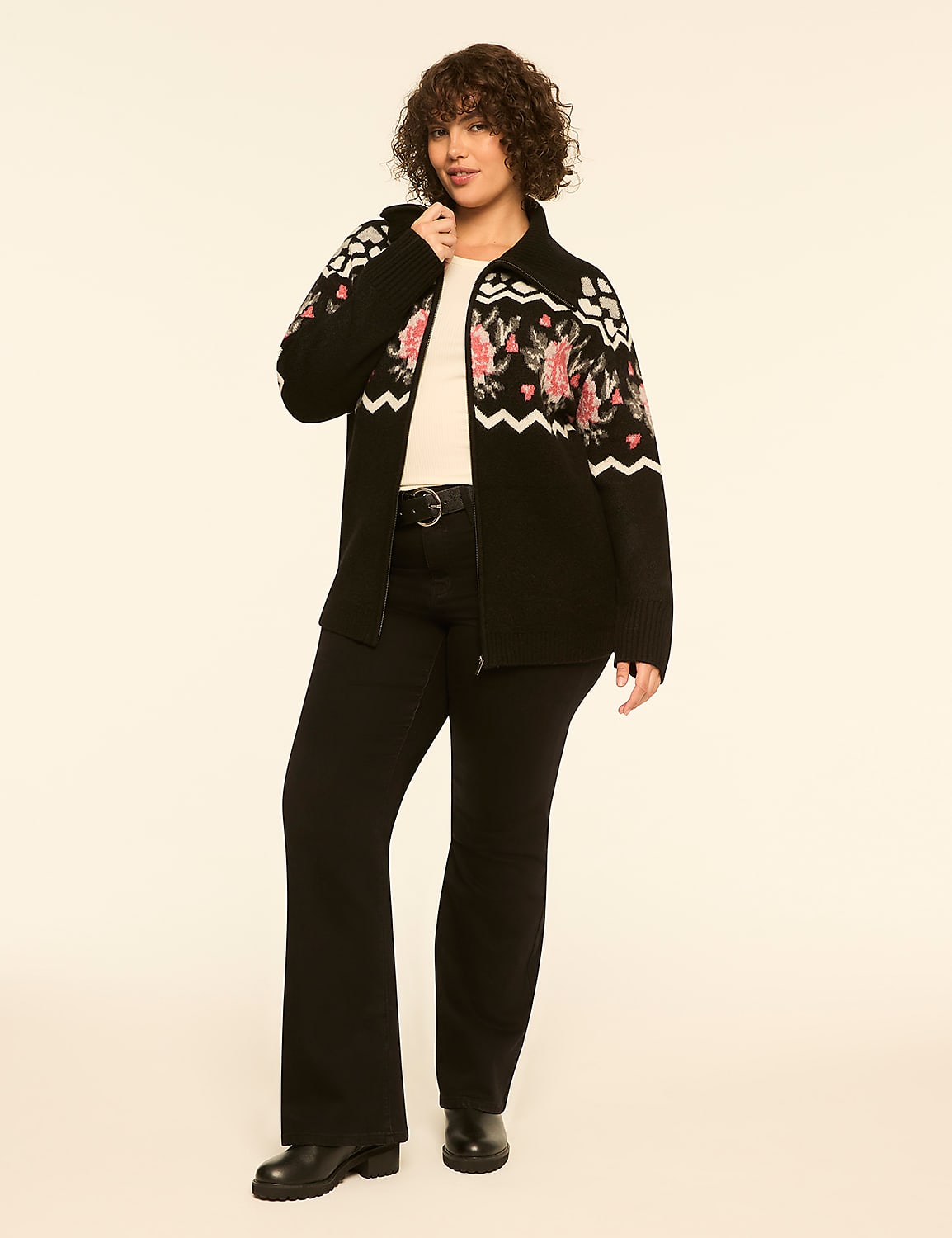 A woman wearing a floral-patterned black cardigan and black flared trousers stands against a plain off-white background. Product Image 3