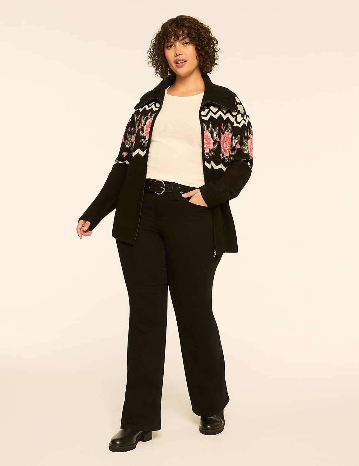 A woman wearing a floral cardigan, white top, and black trousers stands against a plain, light-colored background. Product Image 3