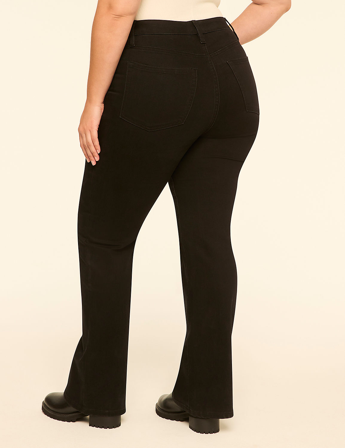 A person wearing black flared pants and black boots stands against a plain, light-colored background. Product Image 2