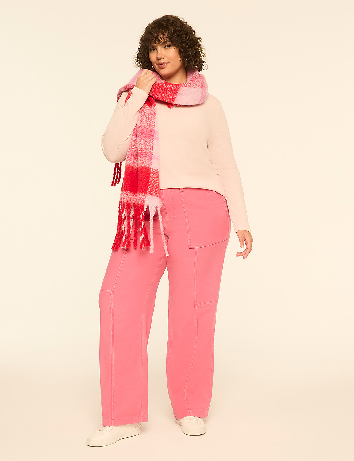 A woman wearing a light pink sweater, pink pants, and a red and pink plaid scarf stands against a plain, light-colored background. Product Image 3