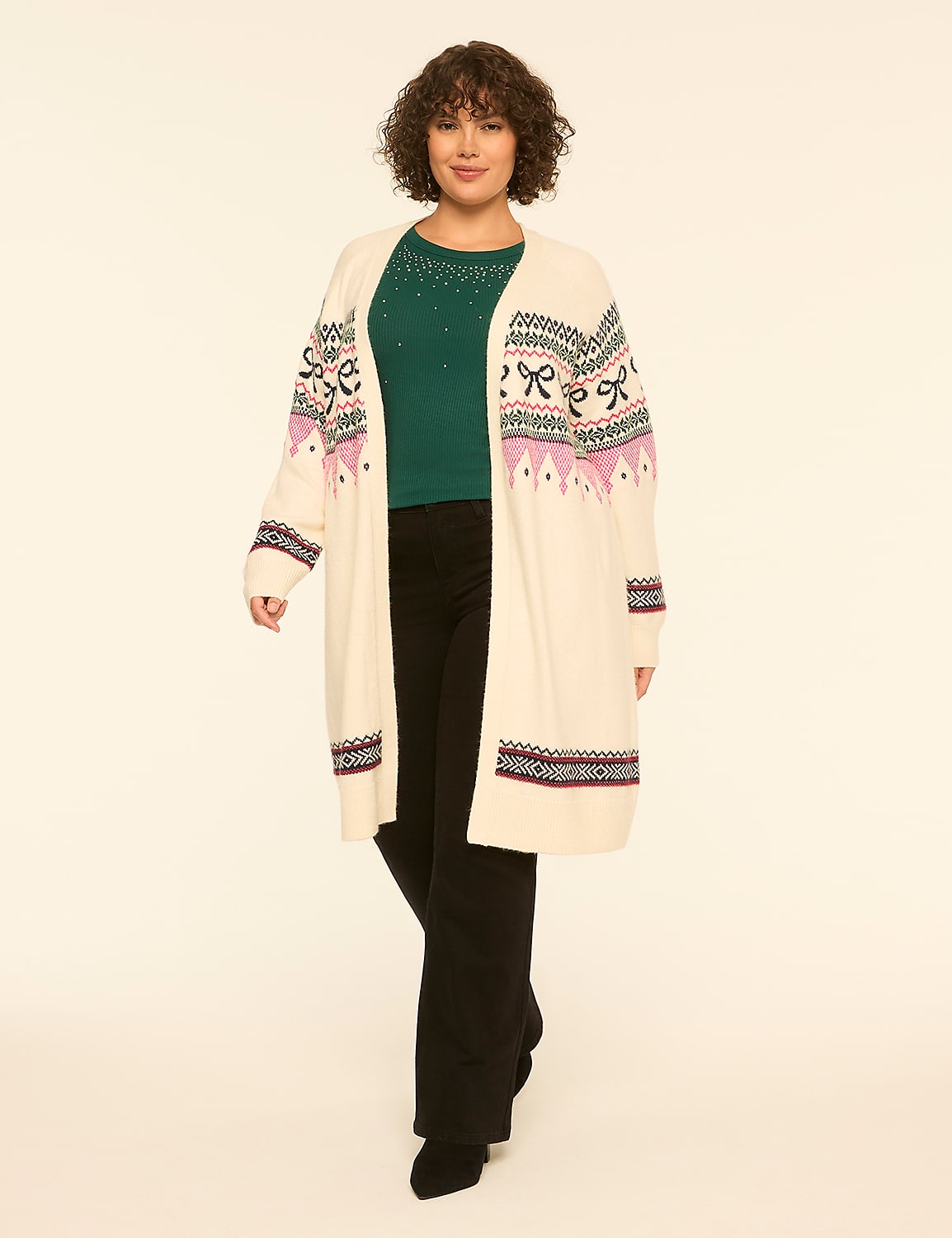 A woman wearing a long cream cardigan over a green top and black pants stands against a plain white background. Product Image 1