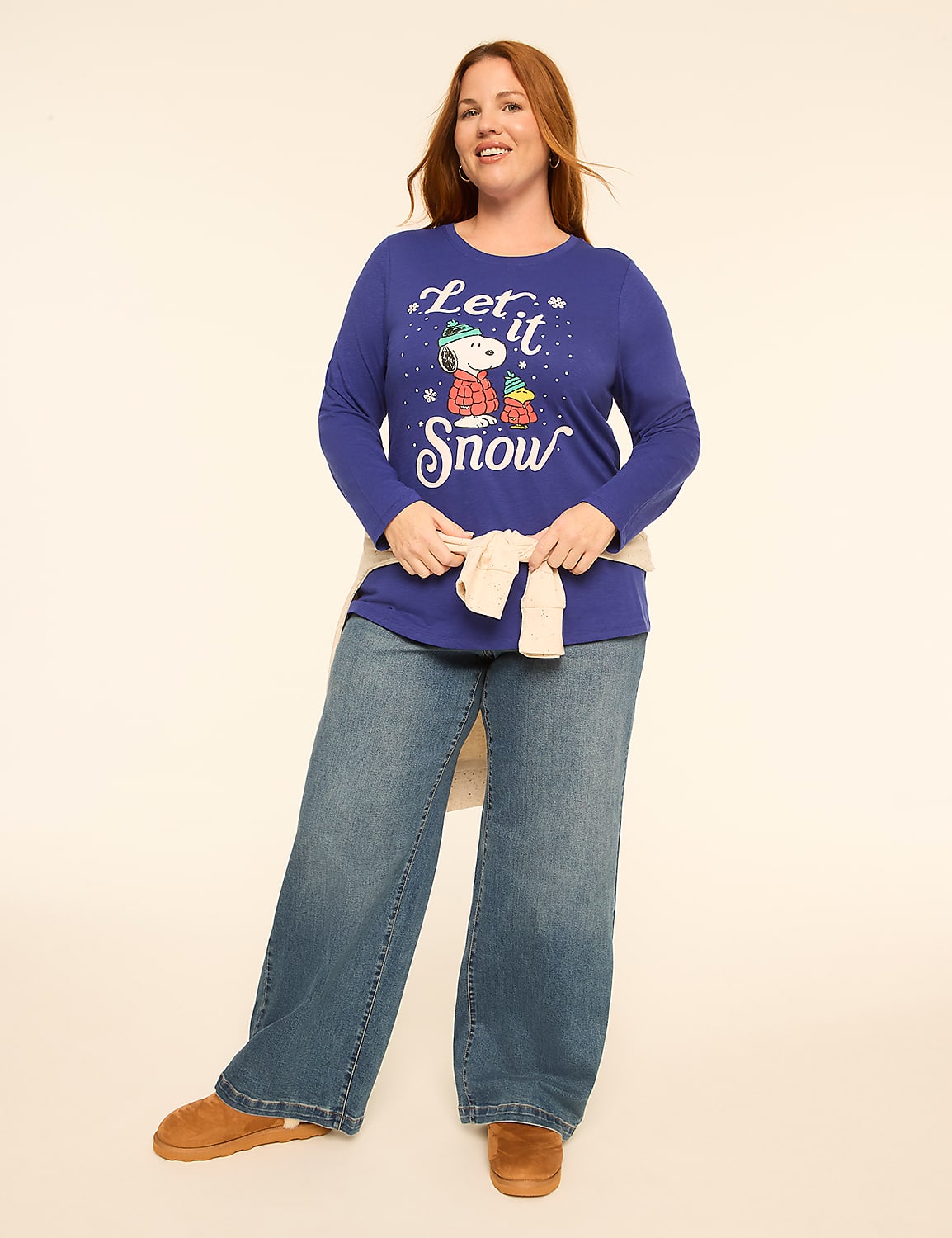 A woman wearing a blue Snoopy sweater and wide-leg jeans stands against a plain white background. Product Image 3