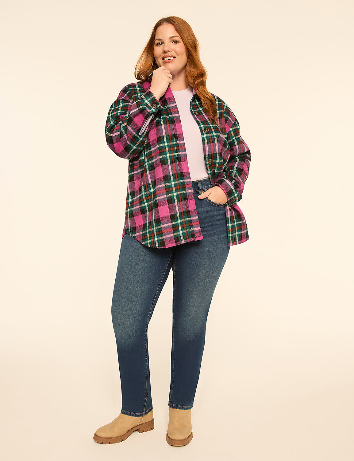 A woman wearing a pink, green, and black plaid shirt over a pink top and blue jeans stands against a plain, light-colored background. Product Image 3