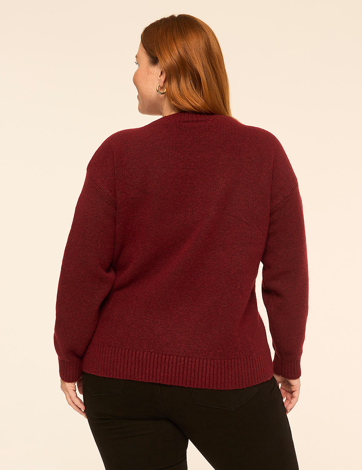 A woman with red hair wearing a burgundy sweater and black pants stands against a plain, light-colored background. Product Image 2