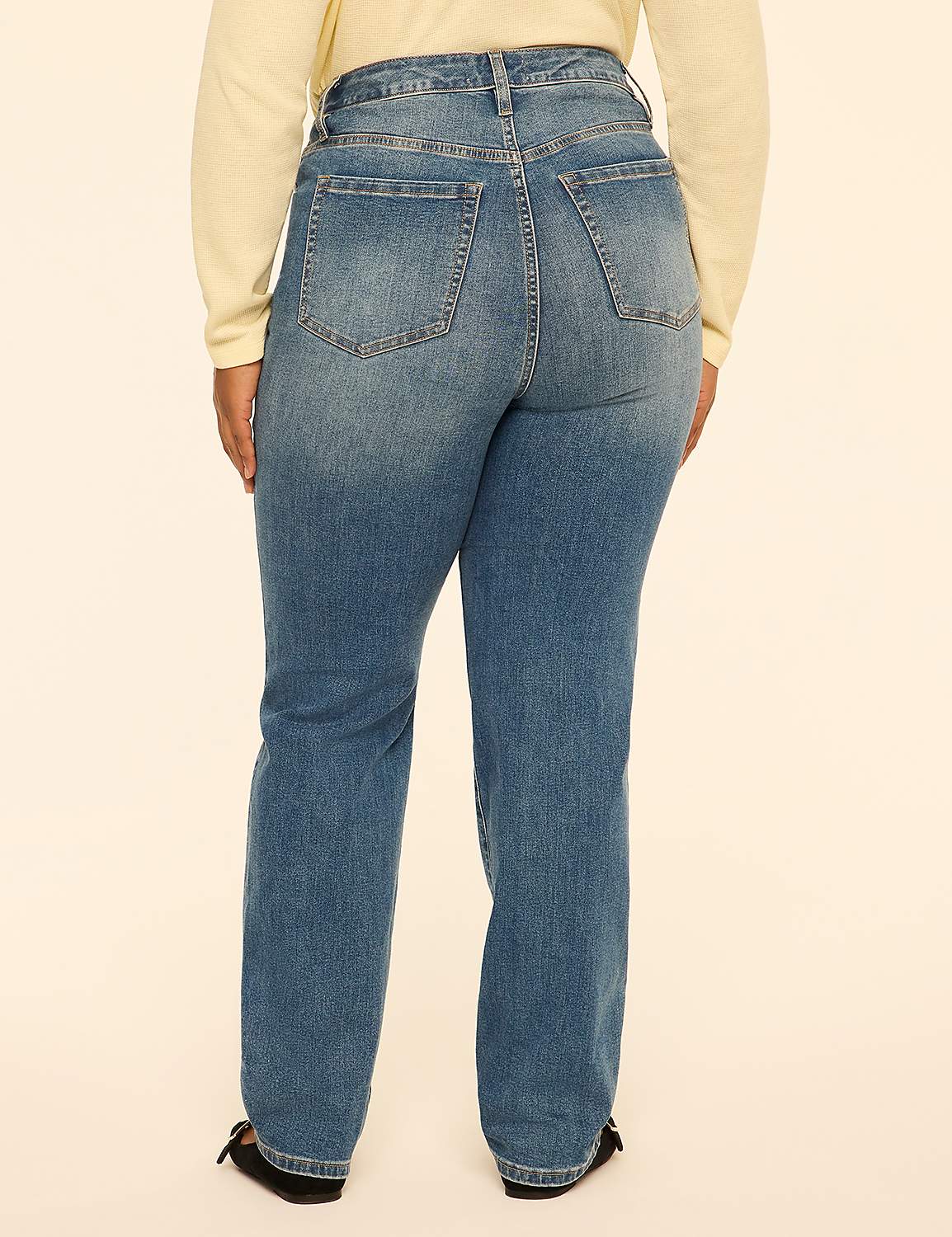 A person wearing blue jeans and a cream-colored top stands against a plain, light-colored background. Product Image 2