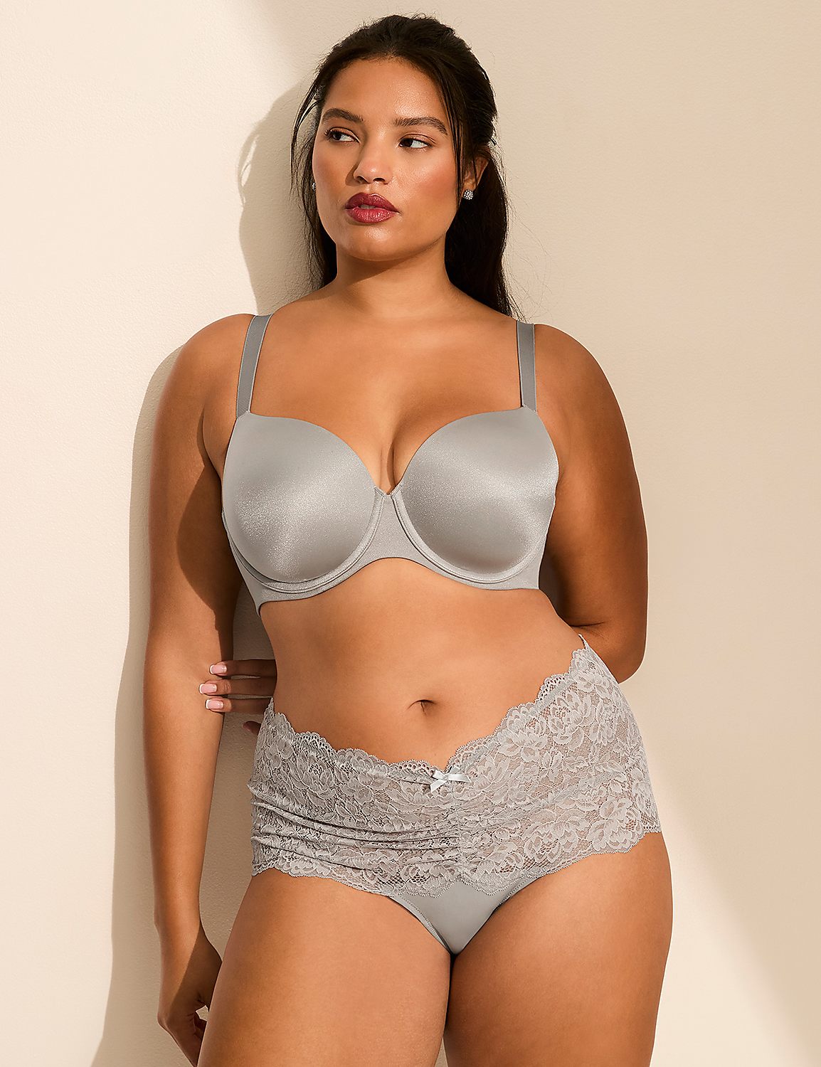 A woman wearing a grey bra and lace panties poses against a plain, light-colored wall. Product Image 3