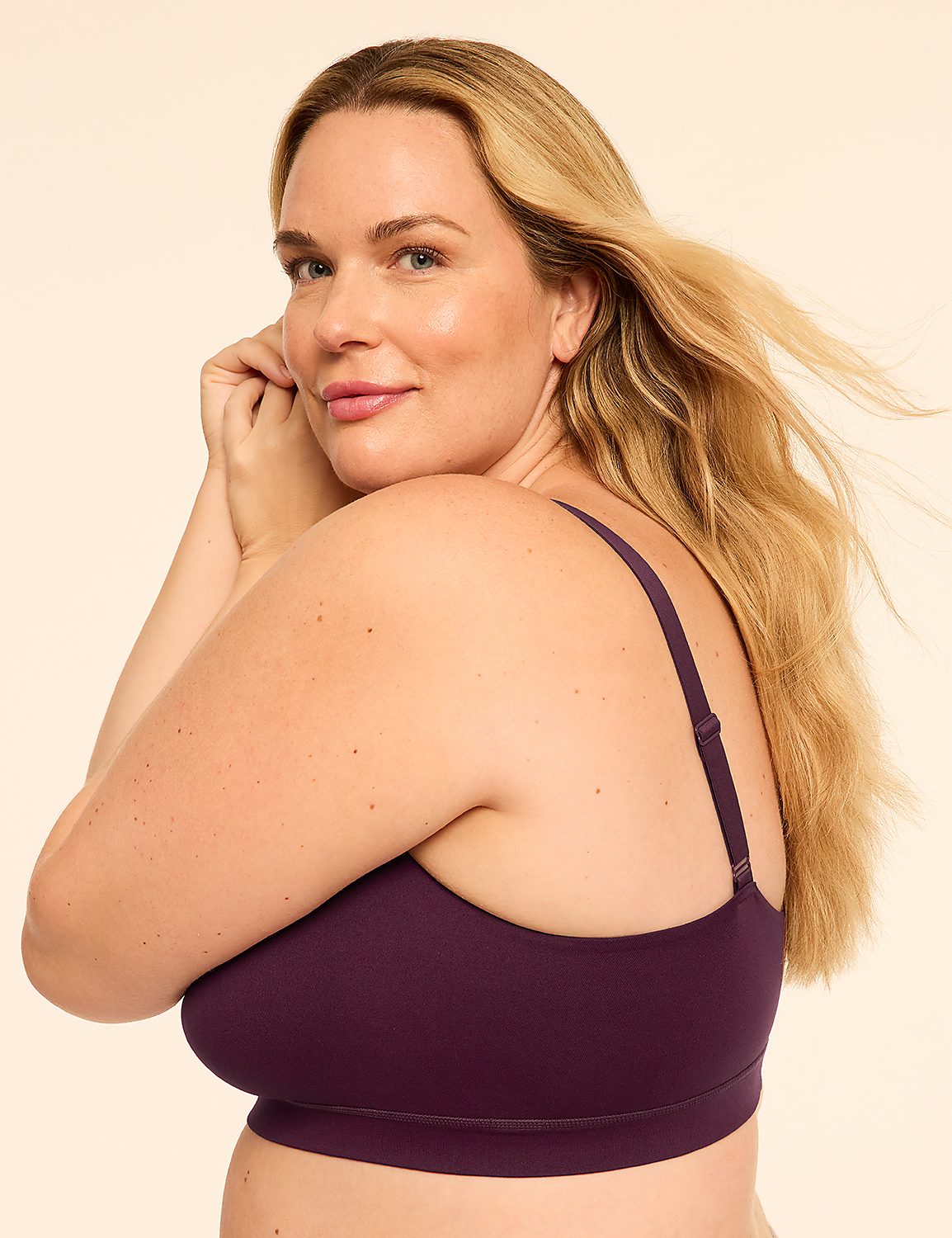 A blonde woman wearing a purple bra poses against a plain, light-colored background. Product Image 3