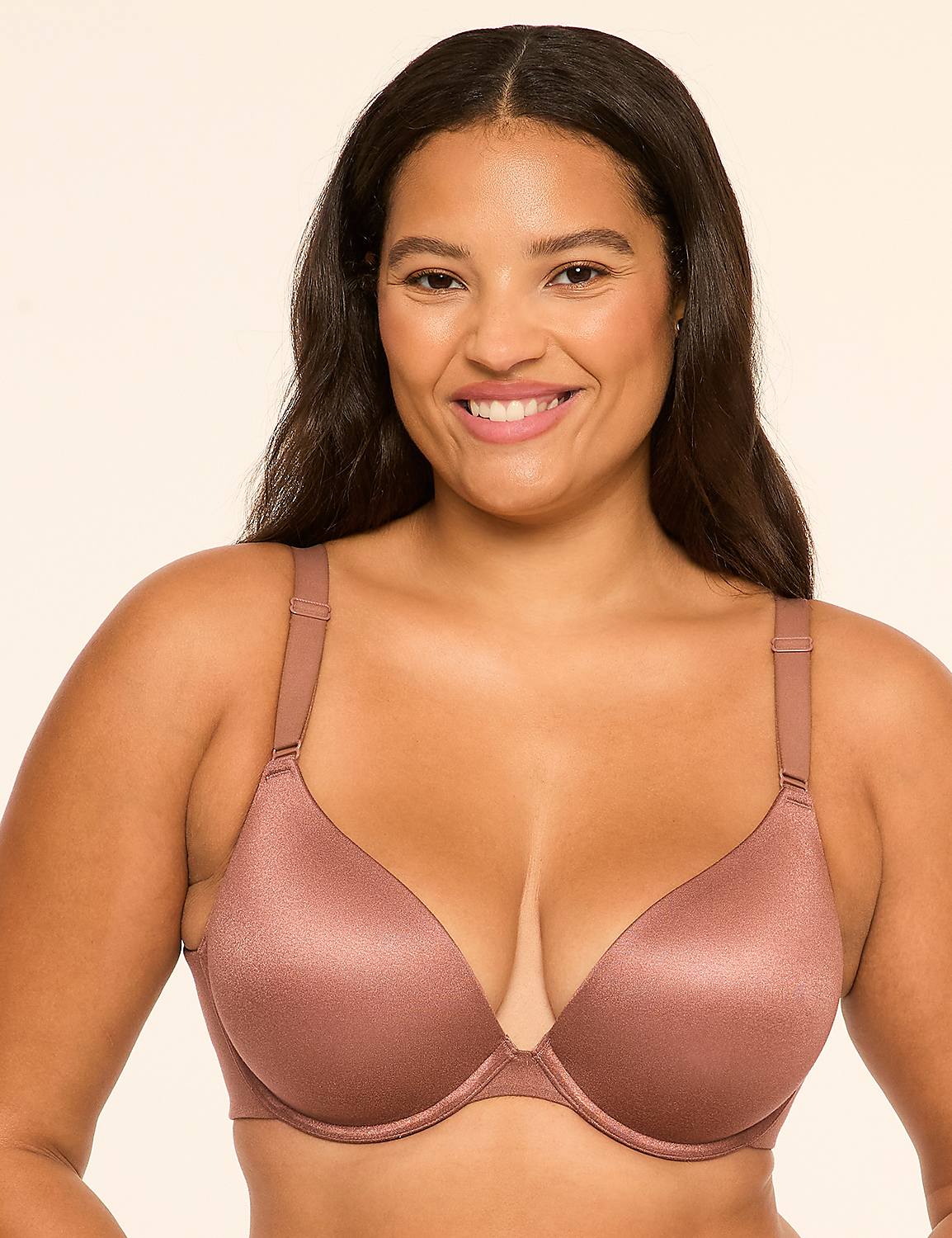 A smiling woman wearing a shimmering mauve bra stands against a plain, light-colored background. Product Image 1