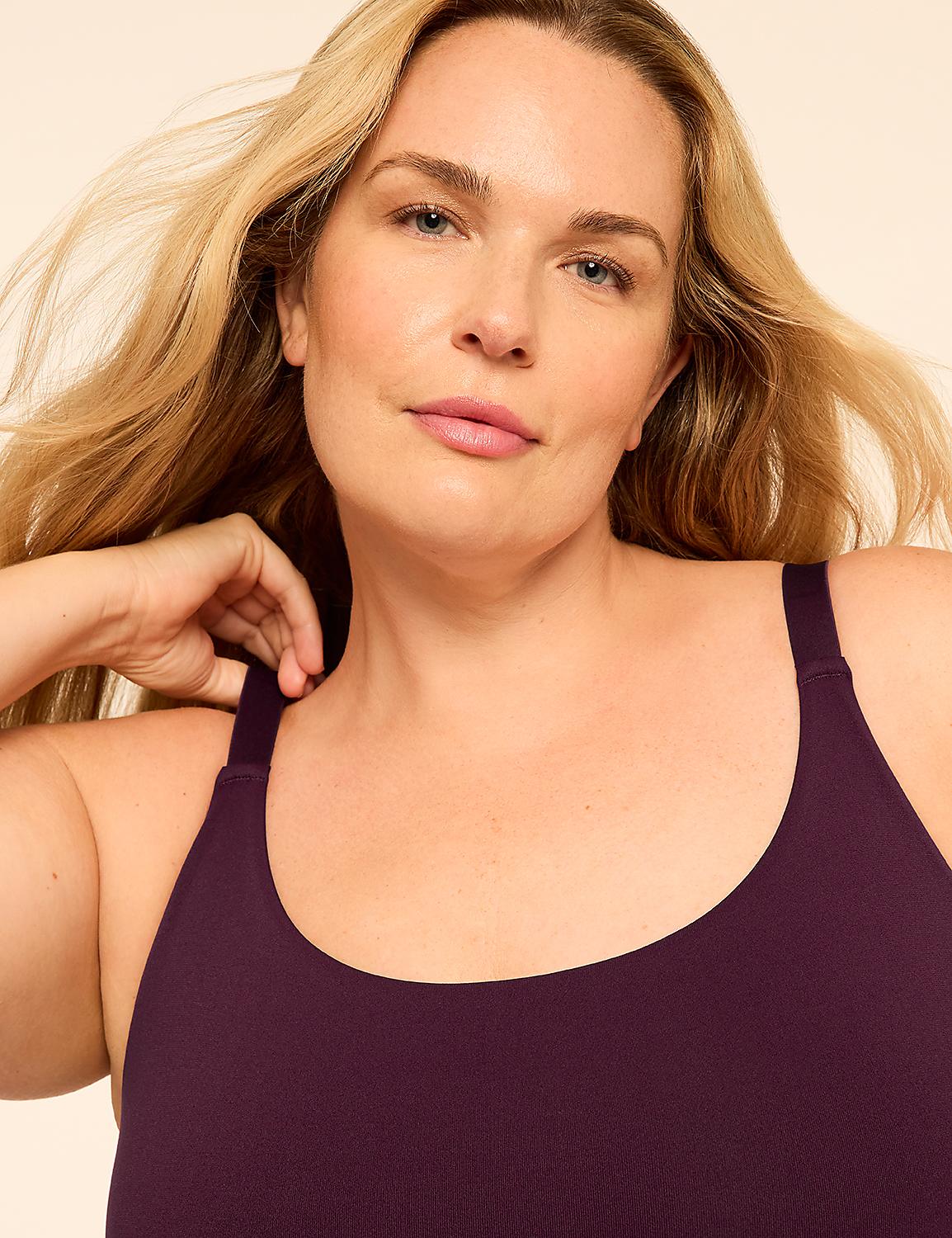 A blonde woman wearing a purple sports bra poses against a plain, light-colored background. Product Image 4